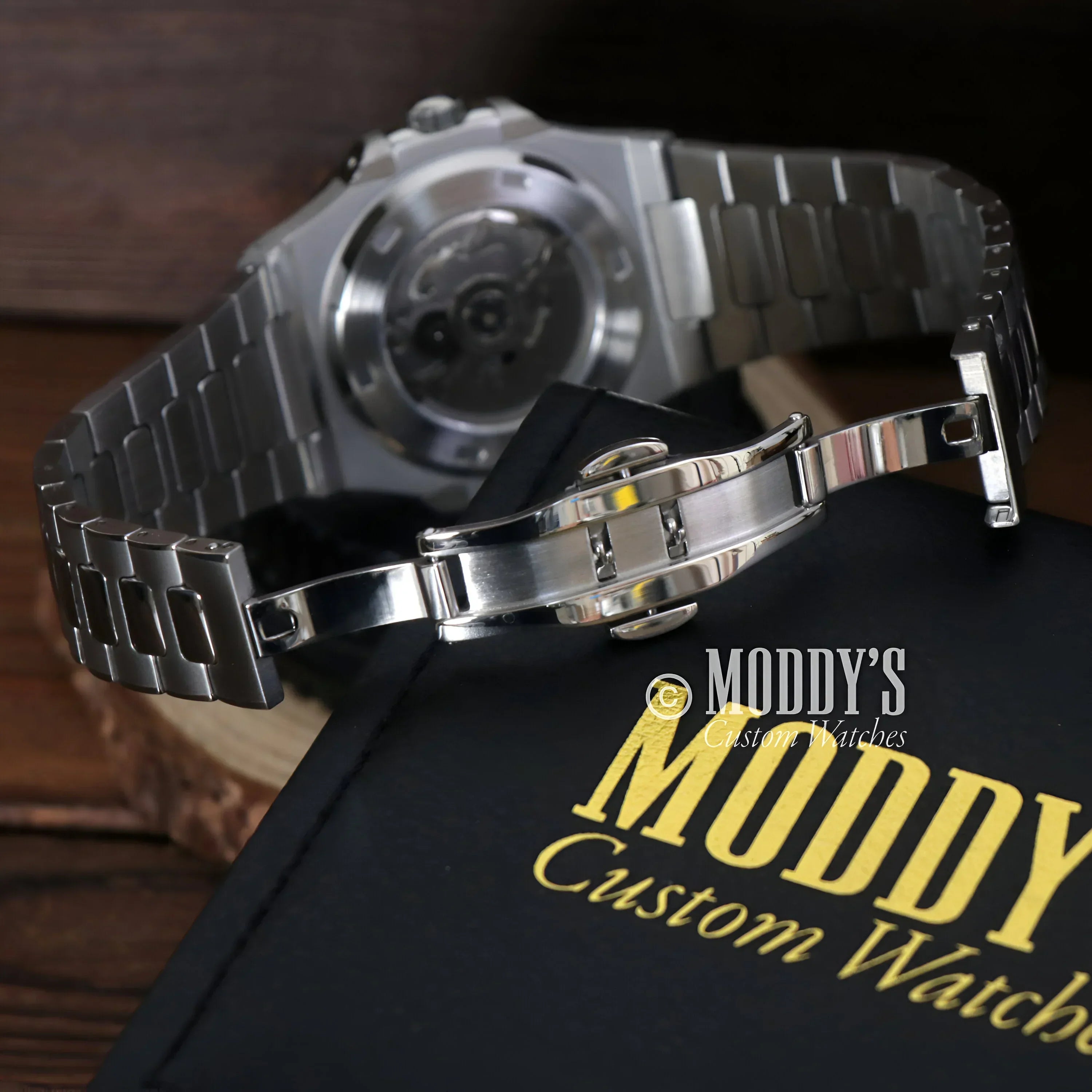 Silver wristwatch with metal band, featuring 904L stainless steel and Seiko NH35 automatic movement