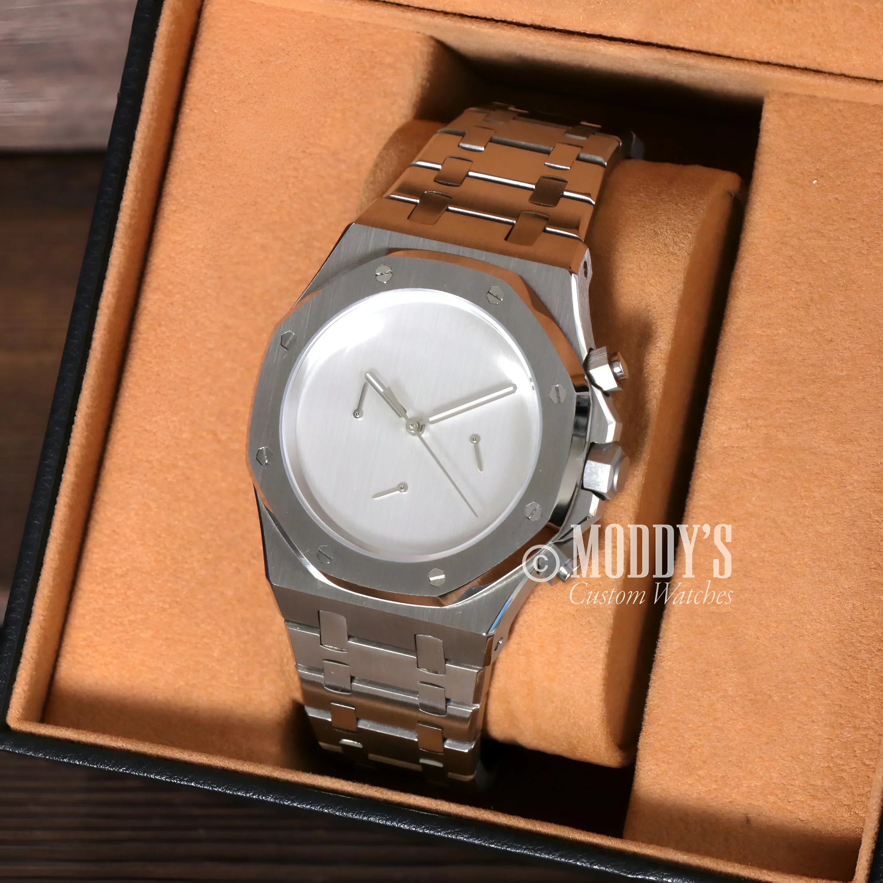 Silver wristwatch with metal band, featuring Royal Oak design and VK63 hybrid movement