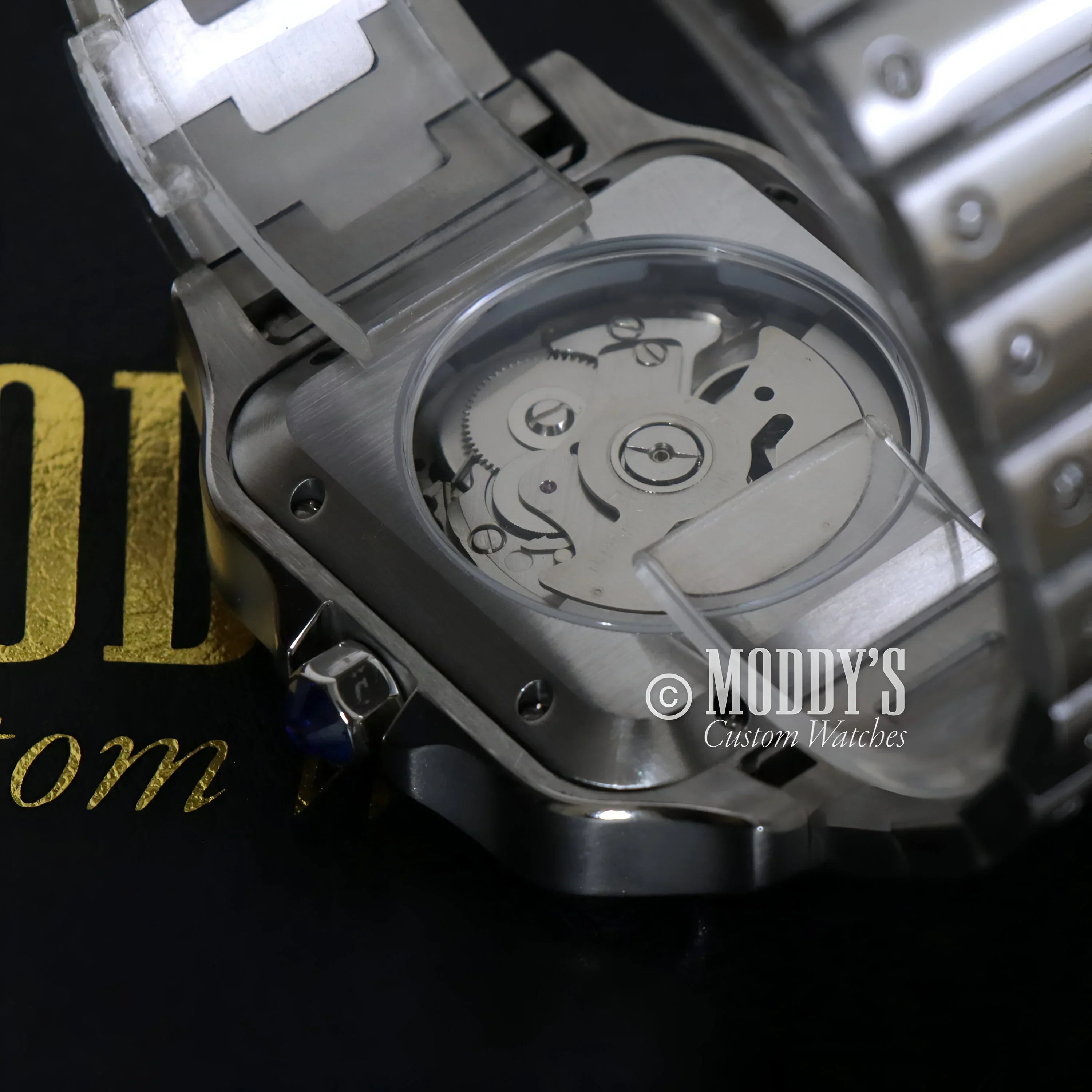 Silver wristwatch with visible movement from Santeiko Black Fck 9 to 5 Seiko mod Santos
