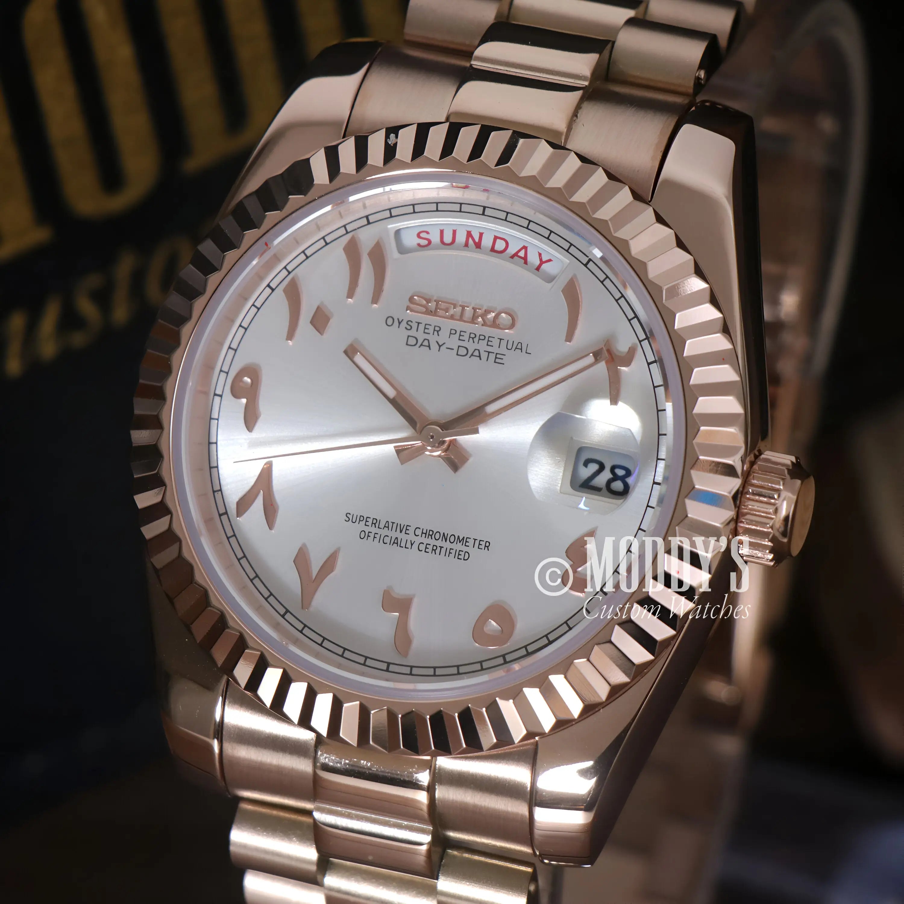Rose gold Seiko mod Day-Date watch with white dial and Roman numerals
