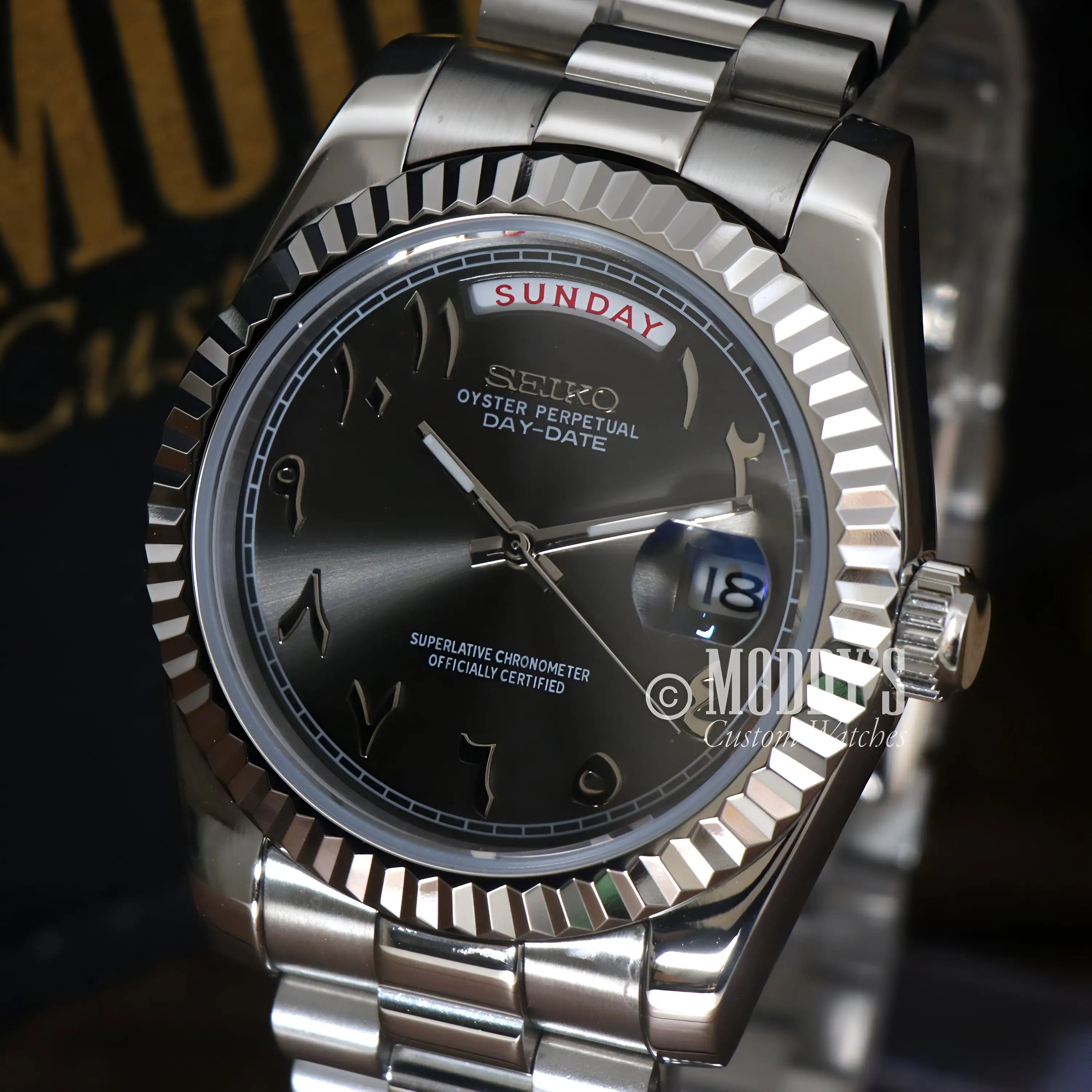 Silver Seiko mod day-date watch with black dial, automatic movement