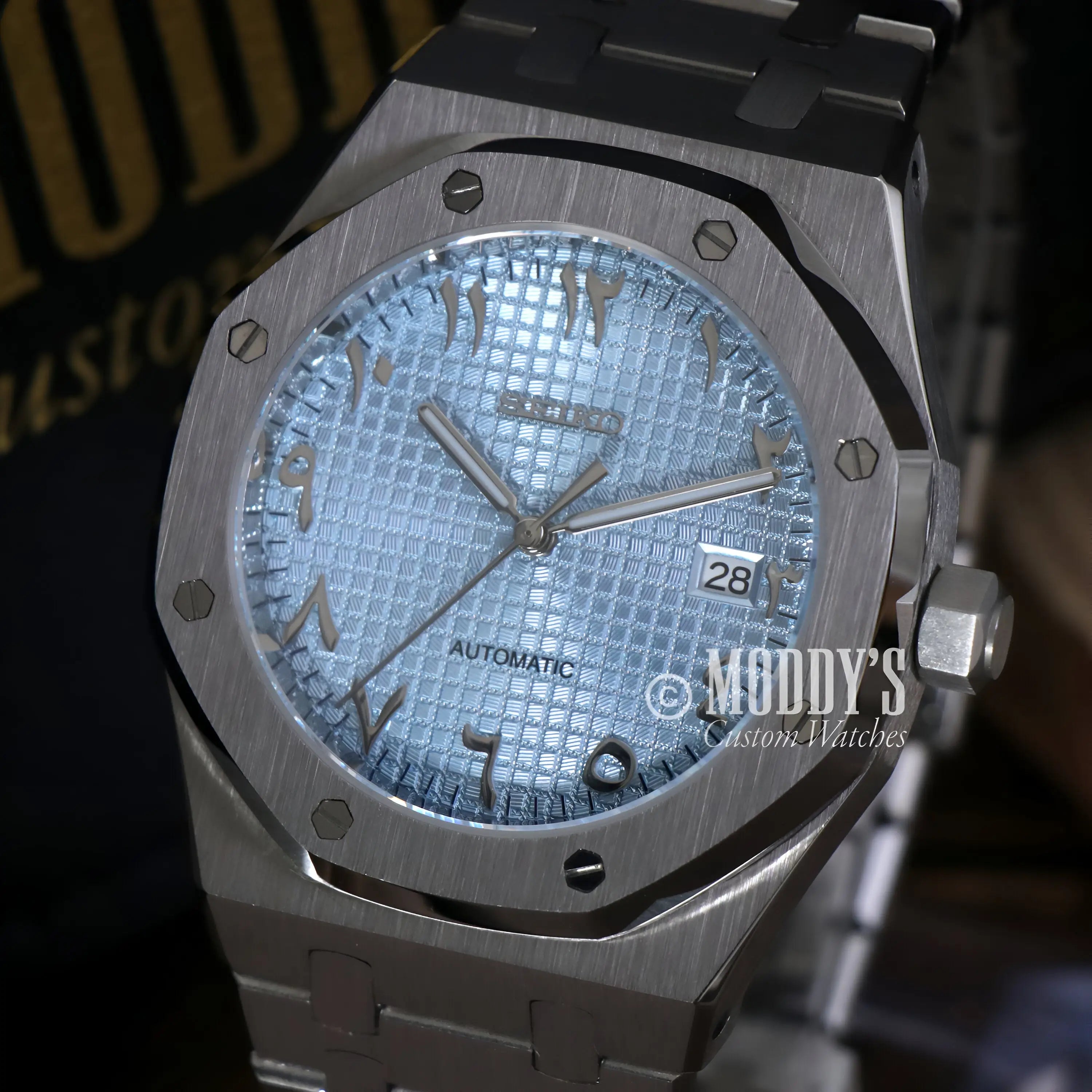 Silver Audemars Piguet Royal Oak mod watch with Seiko NH35 automatic movement, stainless steel bracelet, and textured Arabic ice blue dial