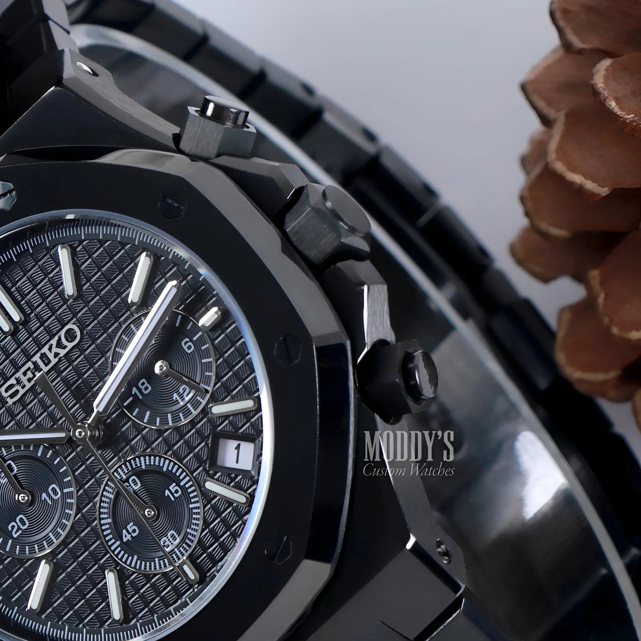 Black Royal Seikoak chronograph with textured dial and date window