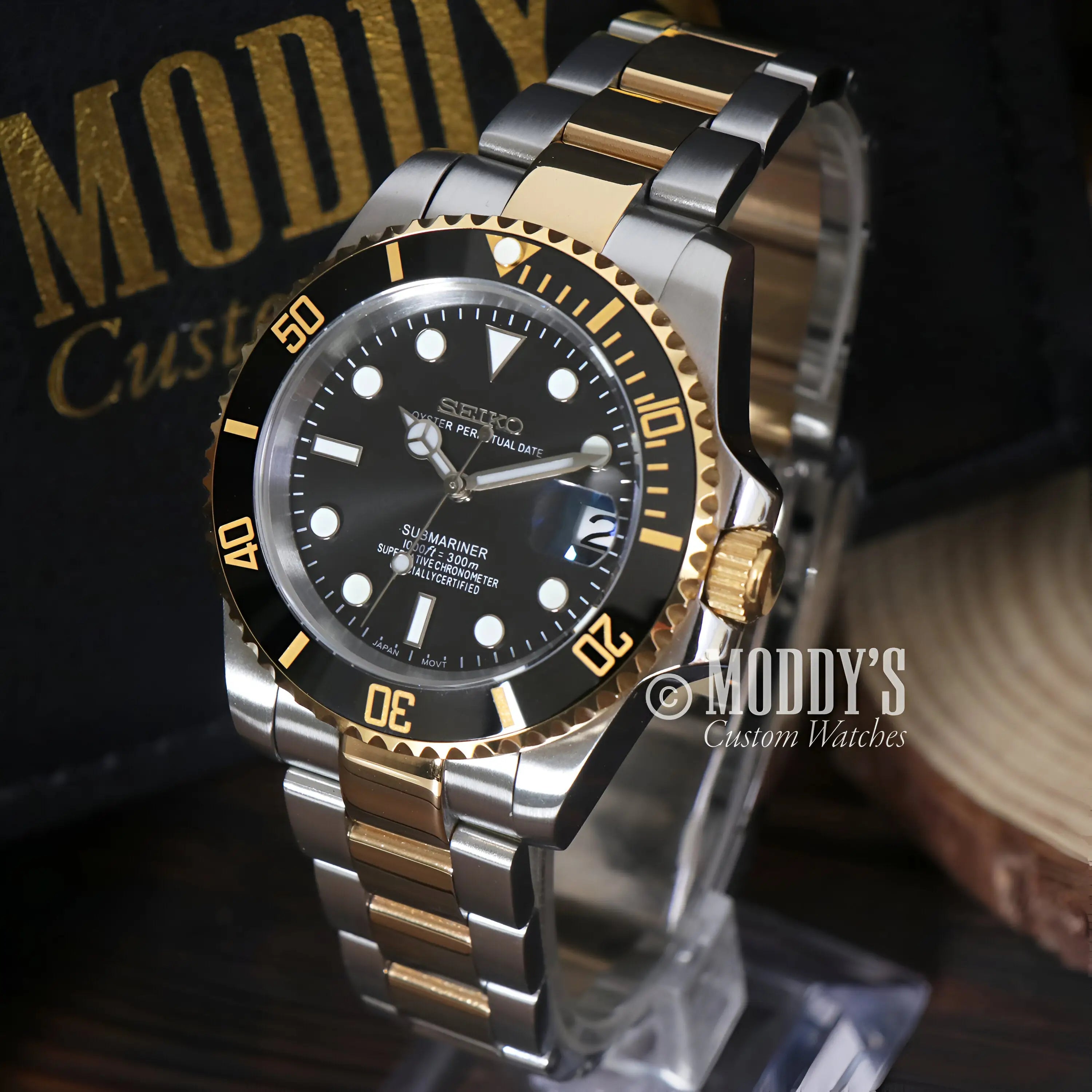 Gold and silver Seiko mod Submariner watch with black dial and NH35 movement