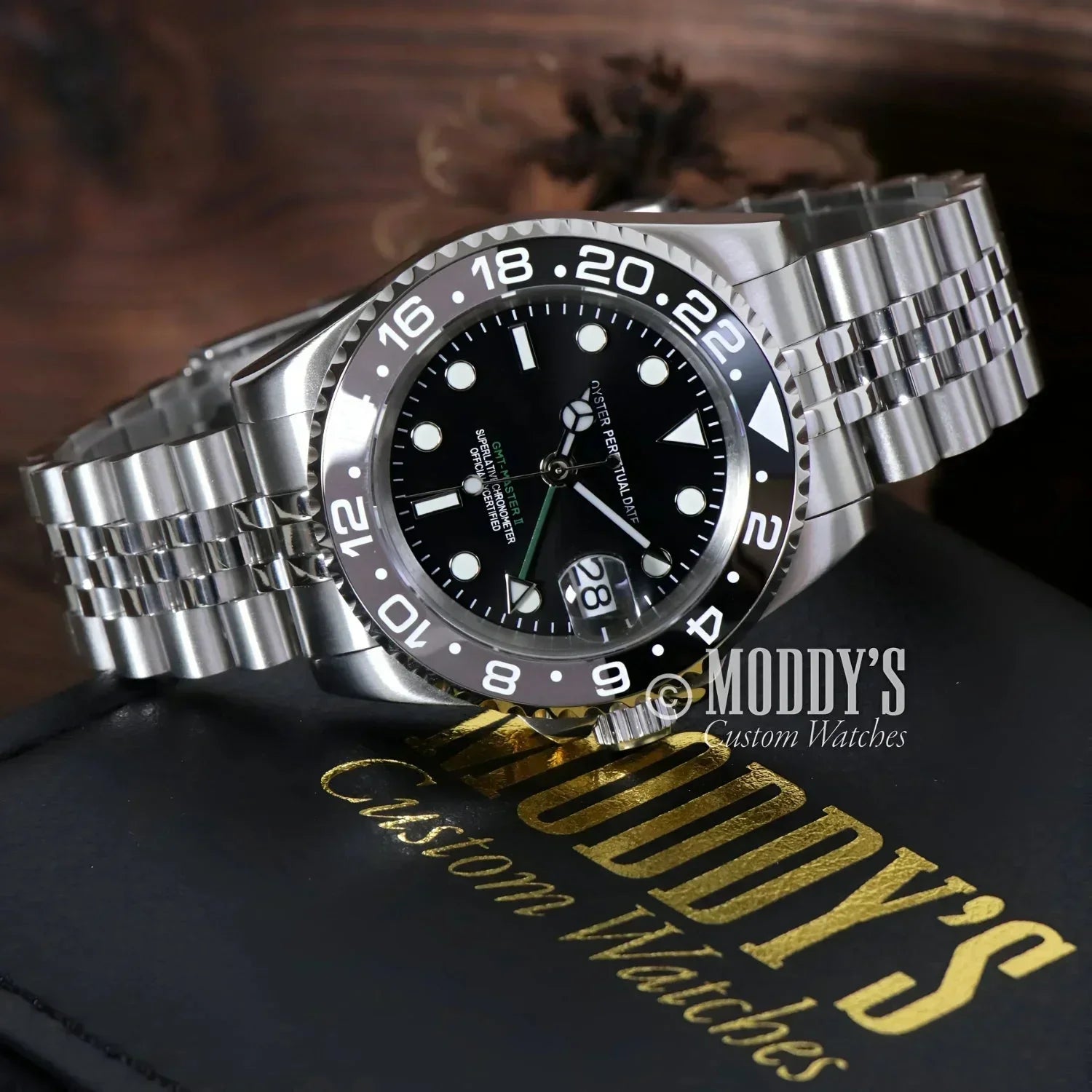 Silver wristwatch with black dial featuring NH34 automatic movement in GMTeiko Bruce Wayne