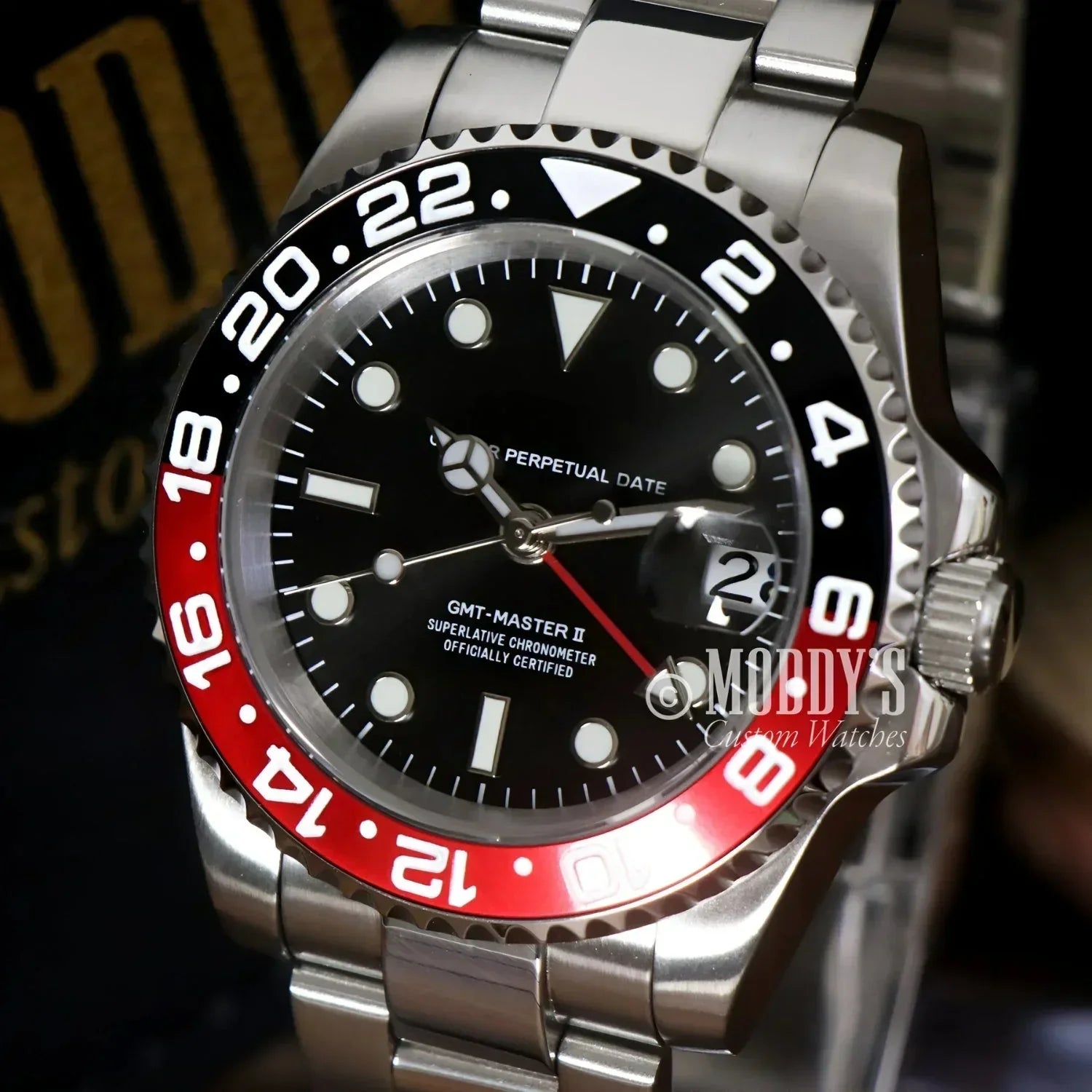Silver GMTeiko Coke wristwatch with red and black bezel, featuring NH34 automatic movement