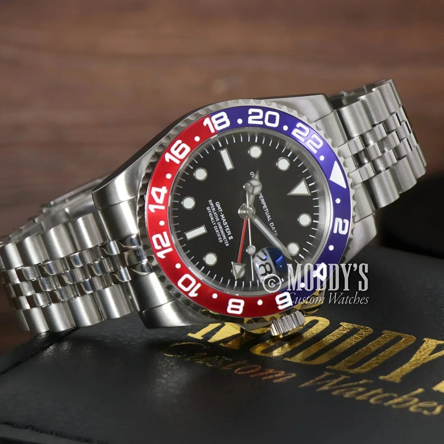 Silver GMTeiko Pepsi wristwatch with red and blue bezel featuring Seiko NH34 automatic movement