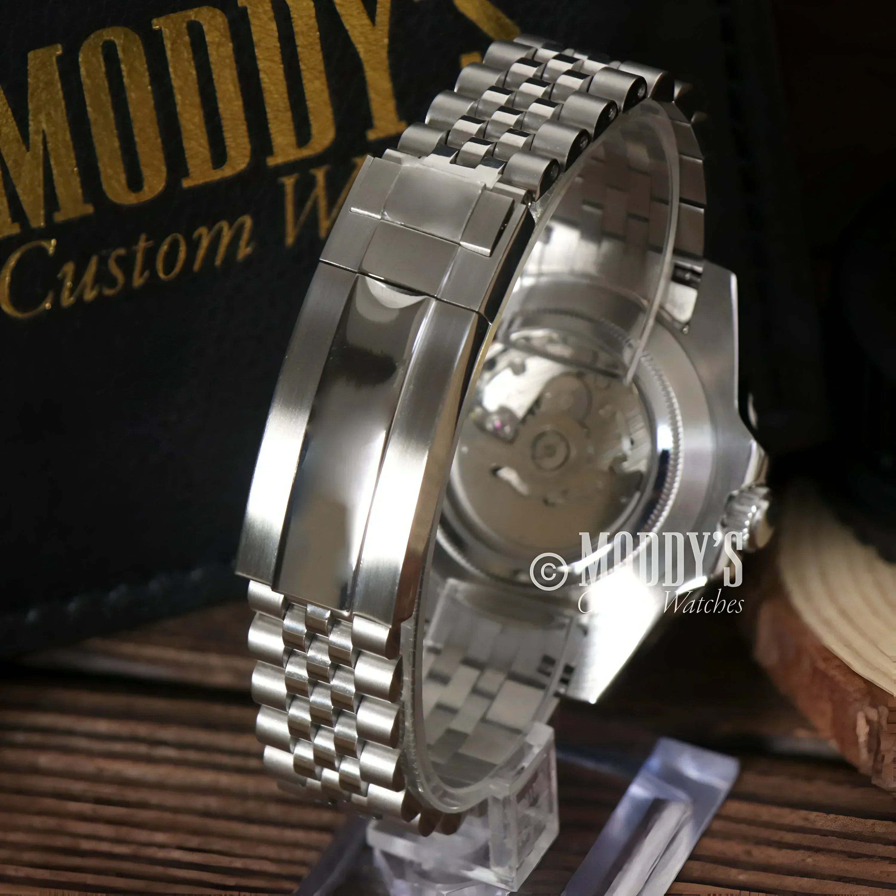 Silver wristwatch with metal band, featuring Seiko NH34 automatic movement in GMTeiko Pepsi