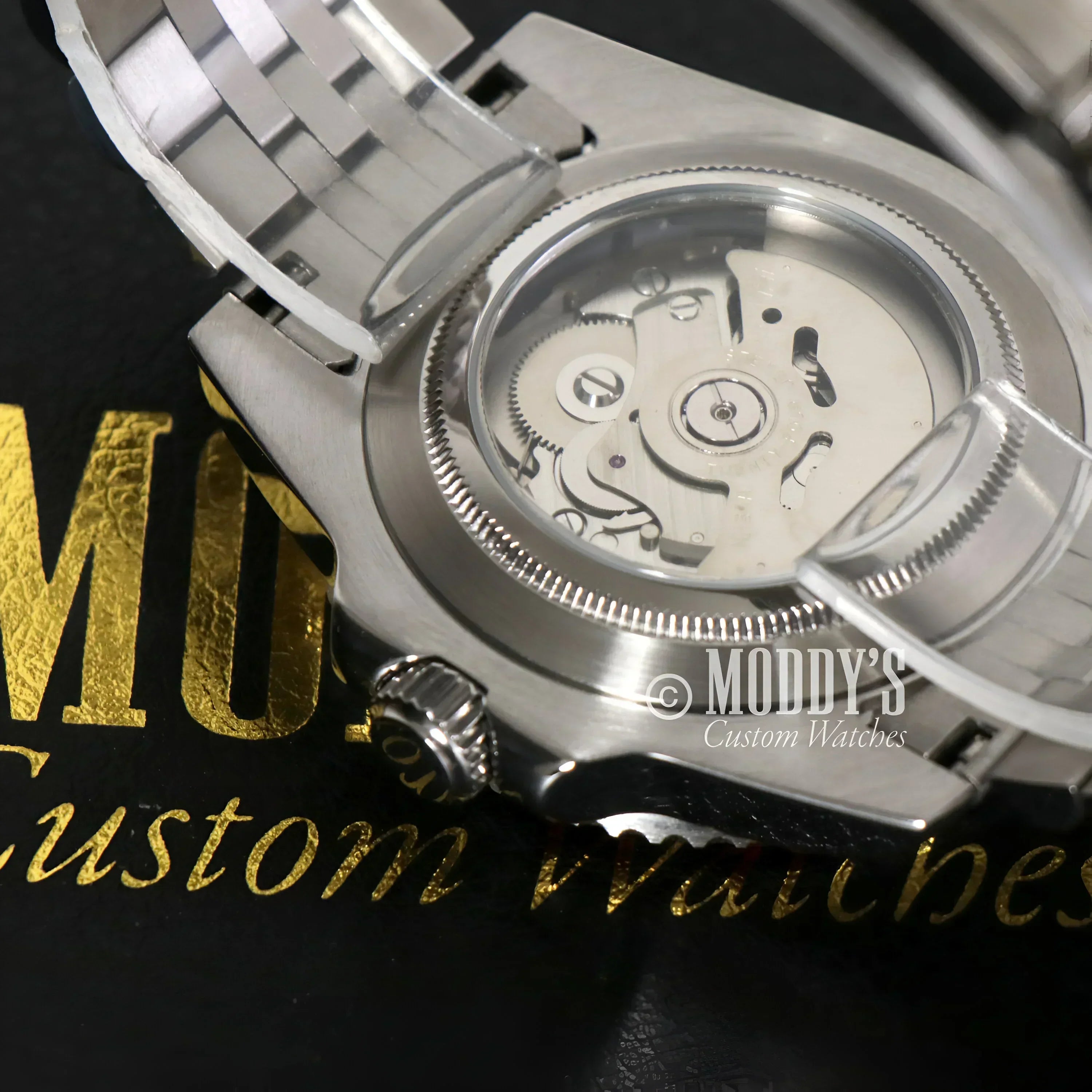 Silver GMTeiko Pepsi wristwatch showcasing Seiko NH34 automatic movement