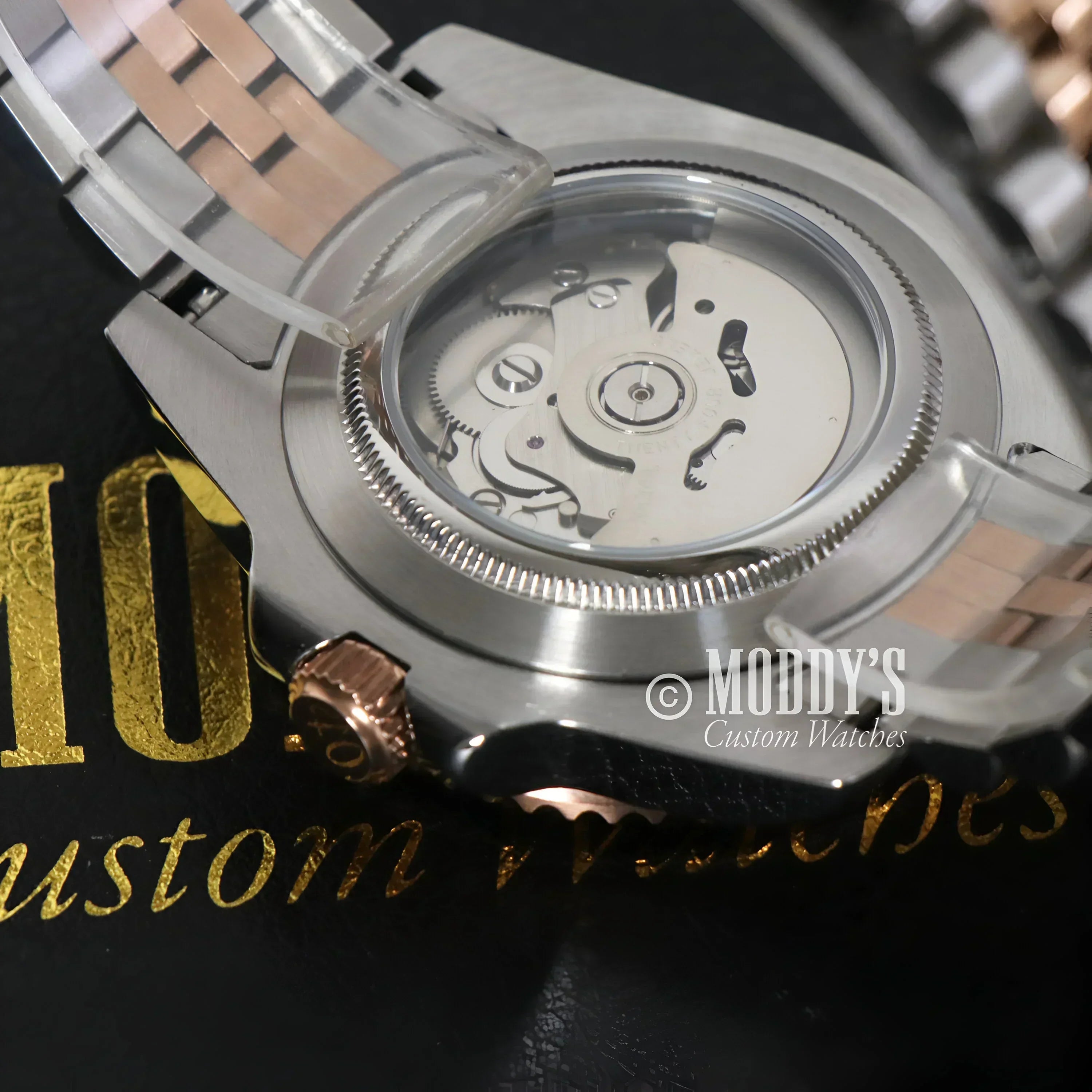 Exposed NH34 automatic movement of GMTeiko Rootbeer in a Seiko mod GMT design