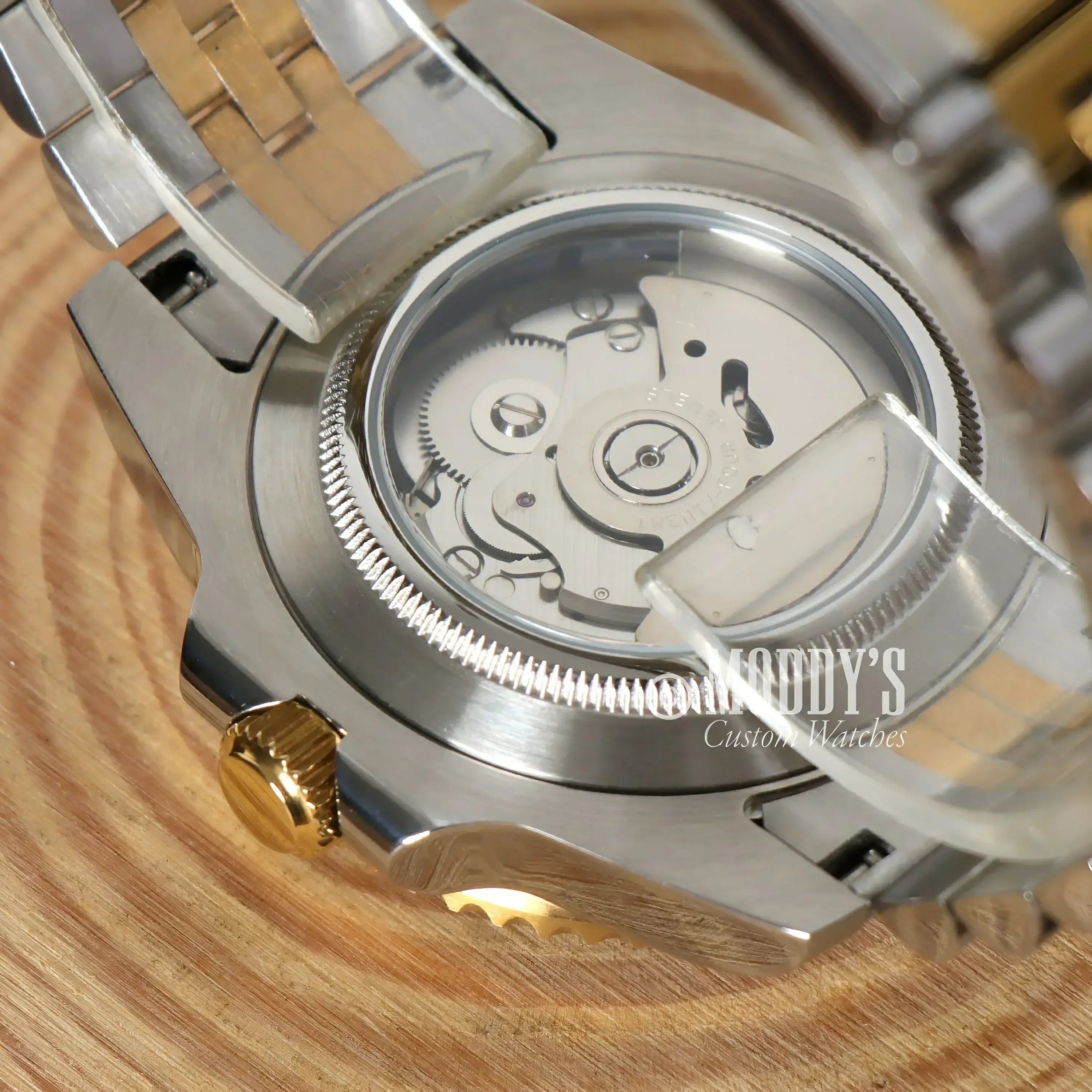 Exposed NH34 automatic movement in GMTeiko Silver Gold with 904L stainless steel design