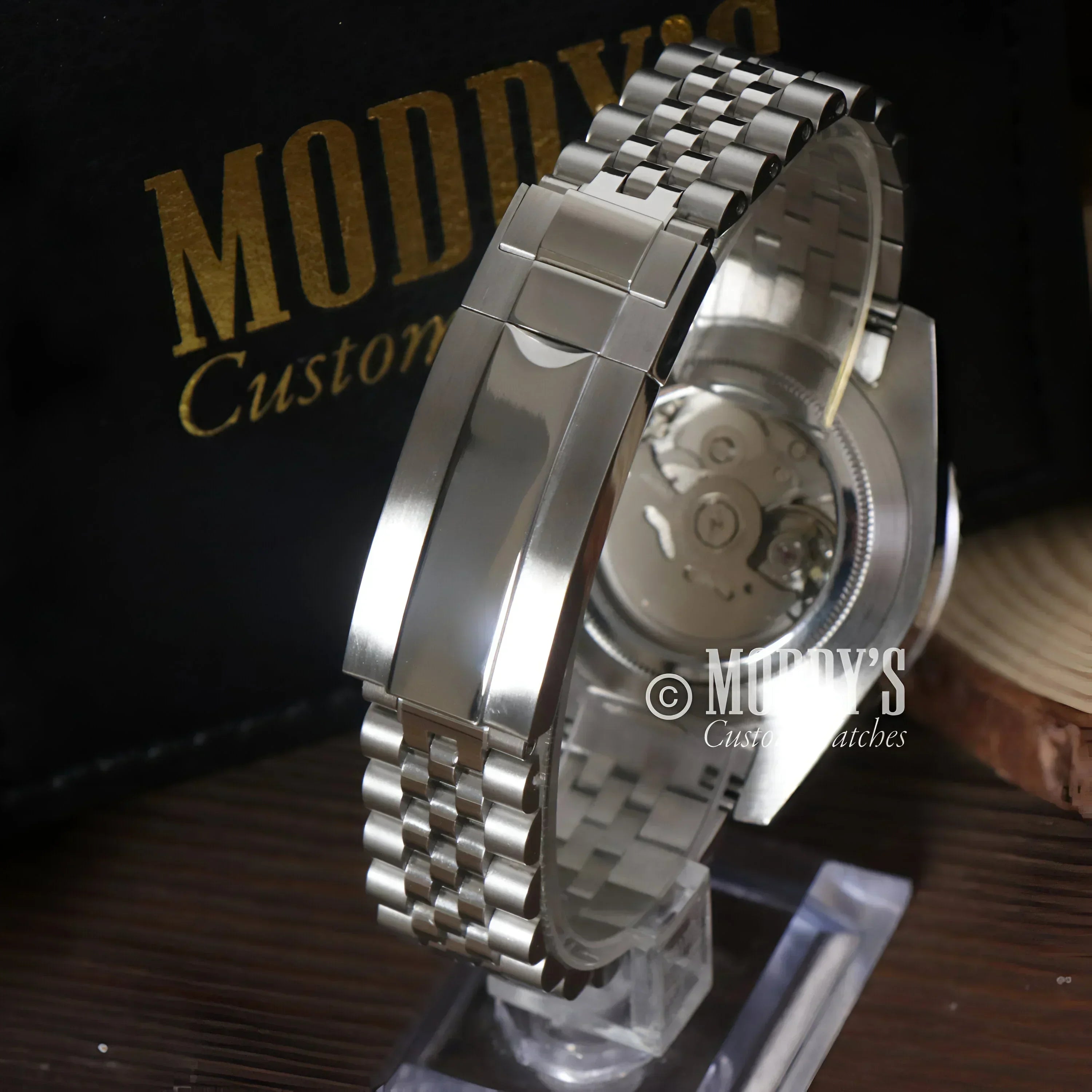 Silver wristwatch with exposed movement featuring Seiko NH34 automatic movement