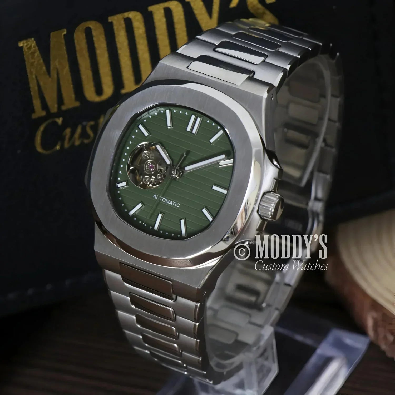 Silver wristwatch with green face featuring NH38 automatic movement, Nautiko design