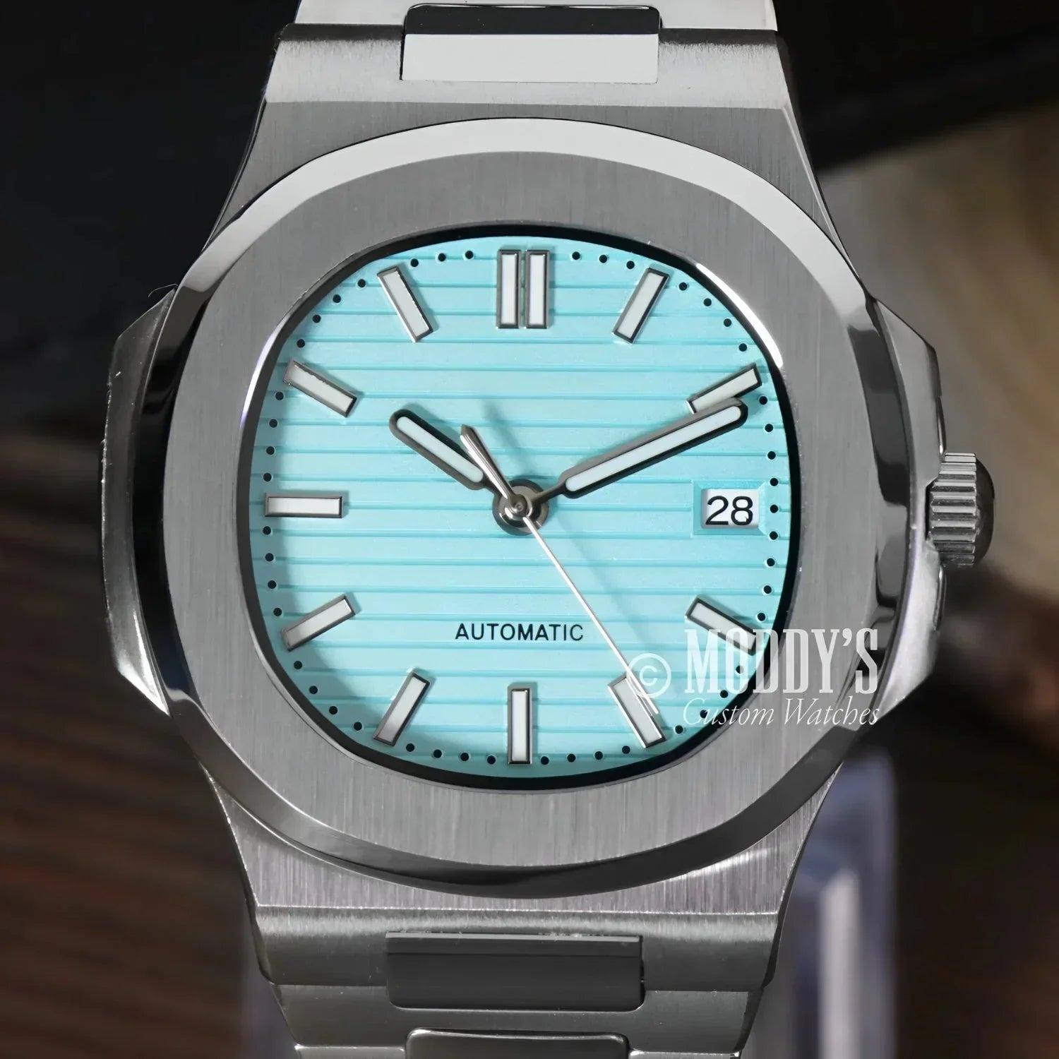 Silver wristwatch with a turquoise face, featuring NH35 automatic movement and Tiffany Blue accents
