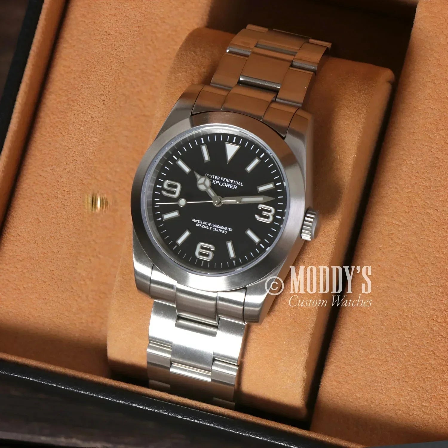Silver wristwatch with black face featuring NH35 automatic movement, Seiko Mod Oyster design