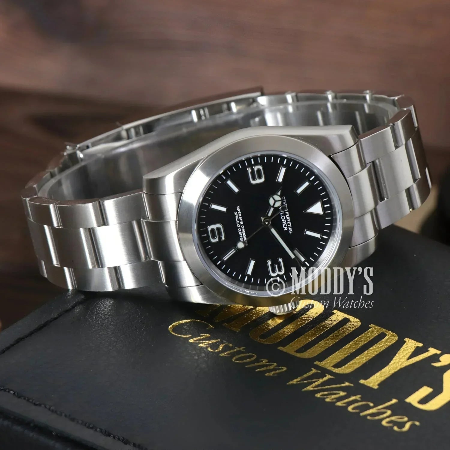 Silver wristwatch with black face, Oysteiko Explorer Black, featuring Seiko mod NH35 automatic movement