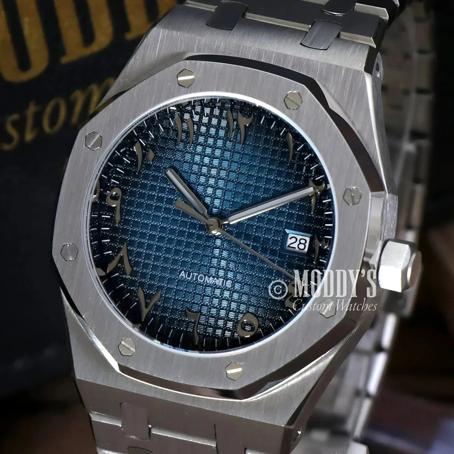 Silver wristwatch Royal Seikoak with blue patterned face and Arabic Blue design