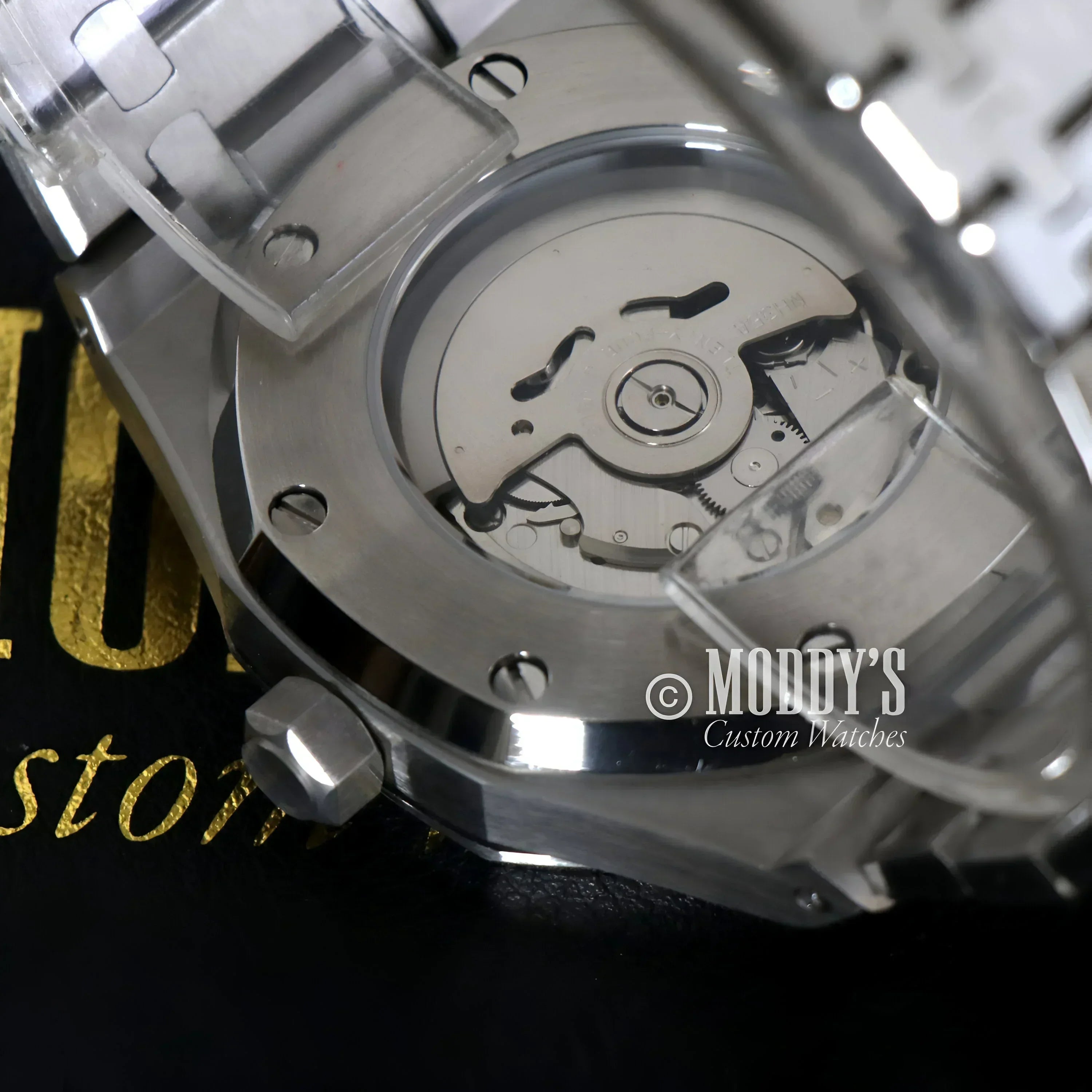 Silver wristwatch mechanism of Royal Seikoak with NH35 automatic movement detail