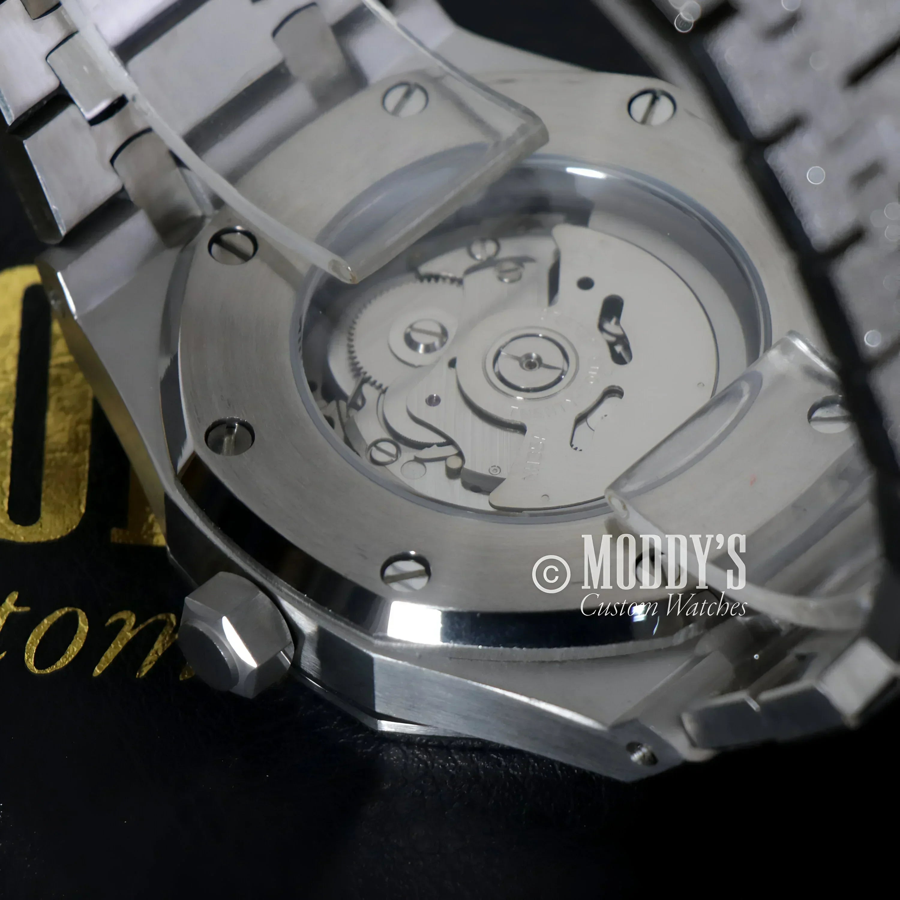 Silver wristwatch with exposed NH35 automatic movement in Royal Seikoak design