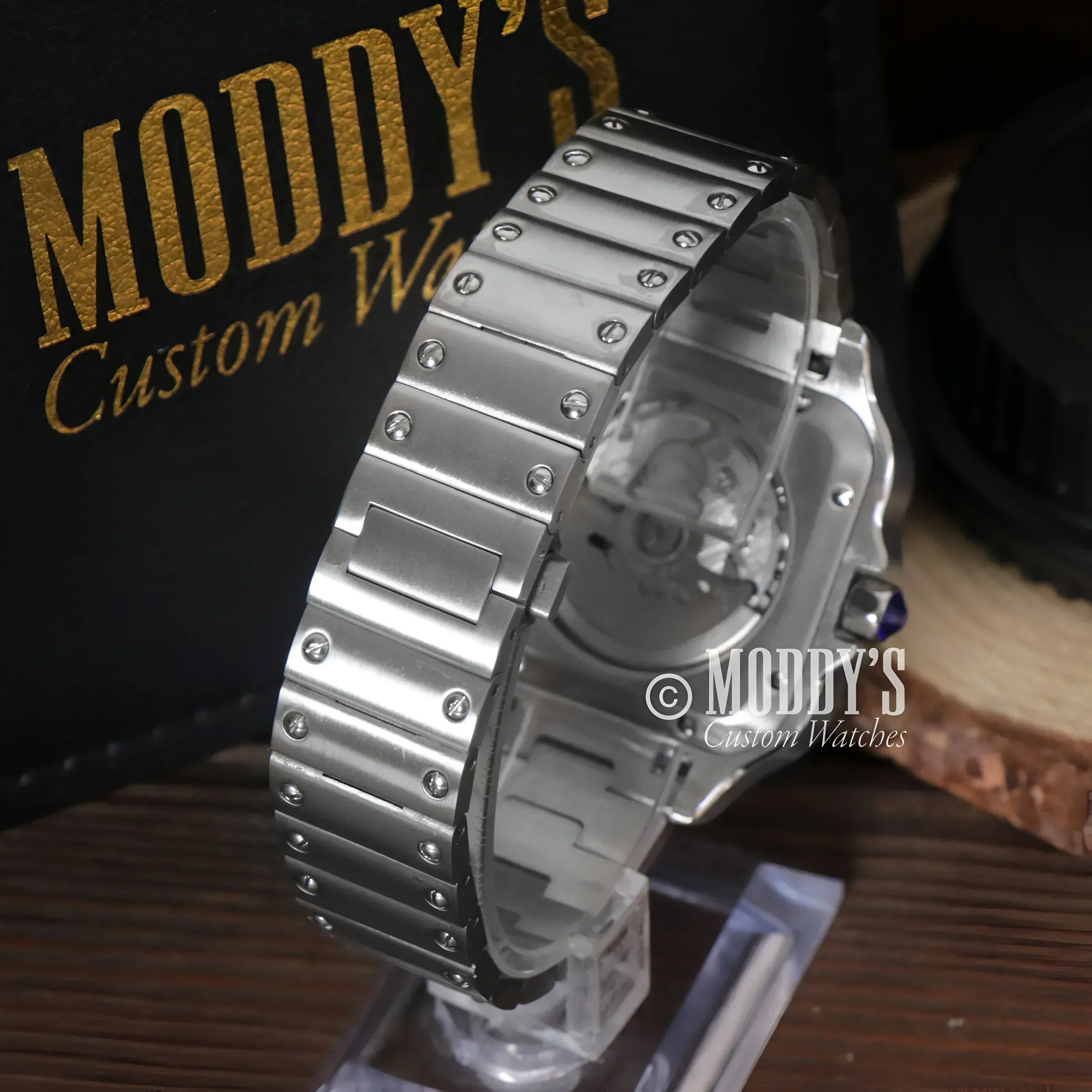 Silver metal watch with linked band featuring Seiko Mod Santos and NH35 automatic movement