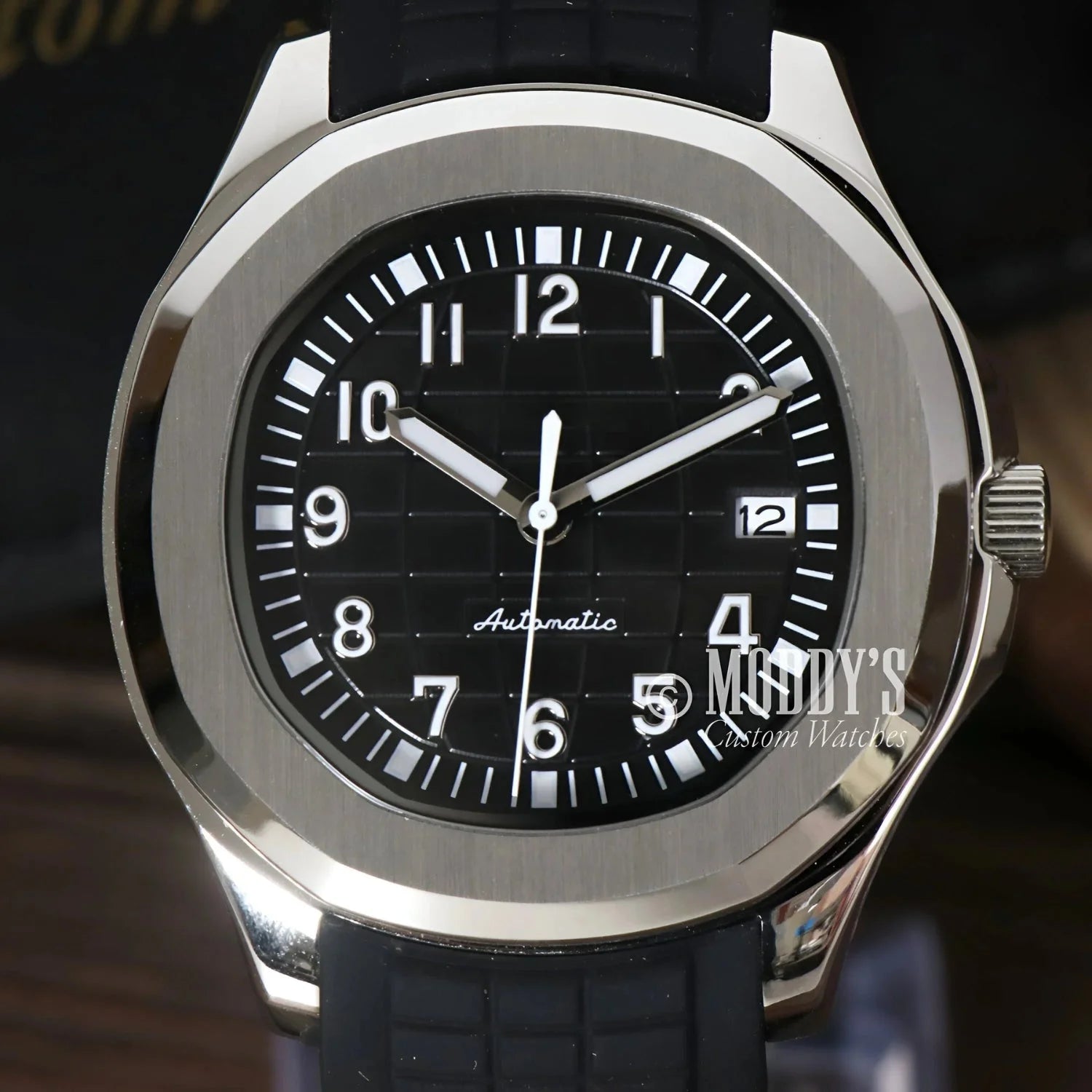 Silver-cased wristwatch with black band featuring Seiko NH35 automatic movement