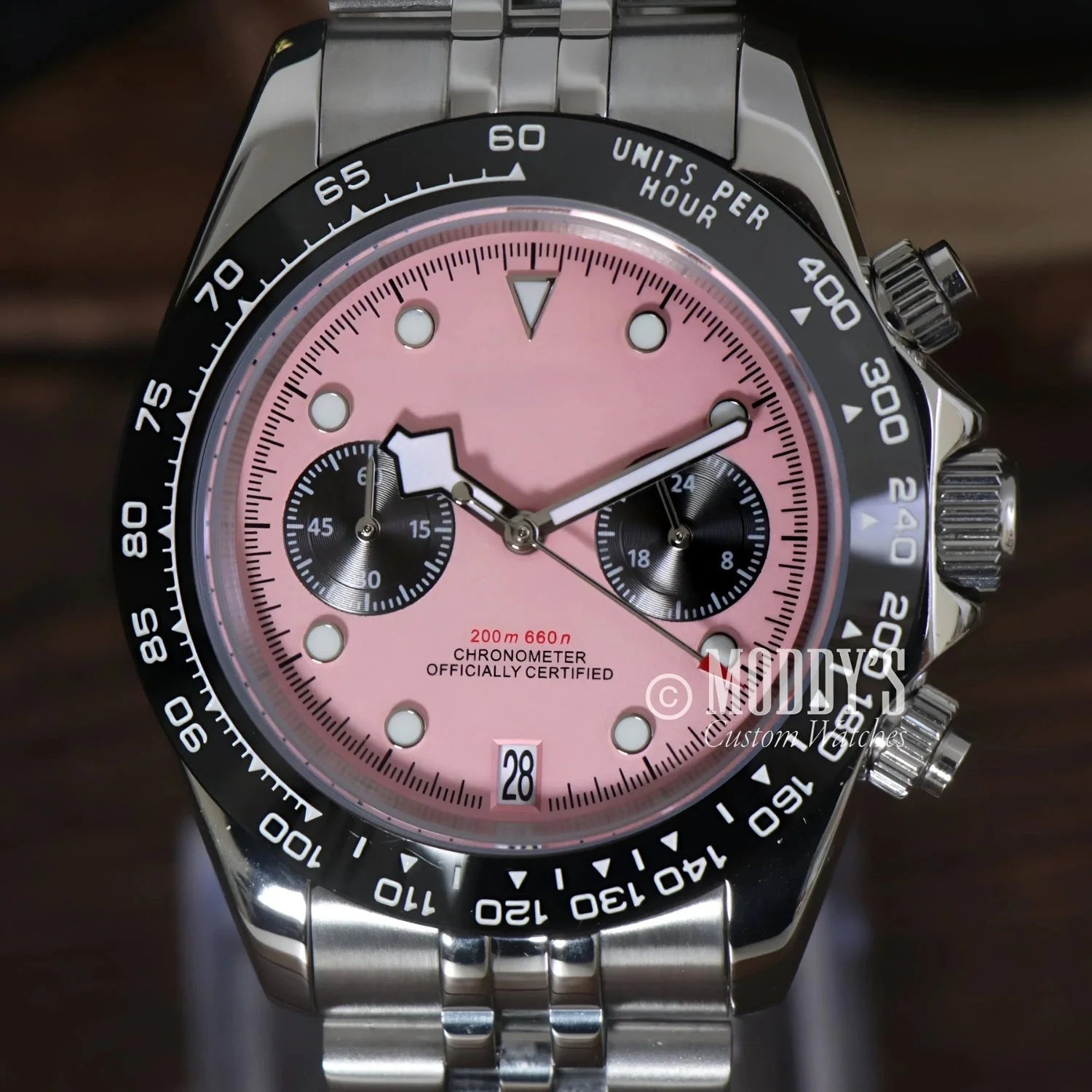 Pink-faced chronograph wristwatch with stainless steel band featuring Seiko VK63 hybrid movement