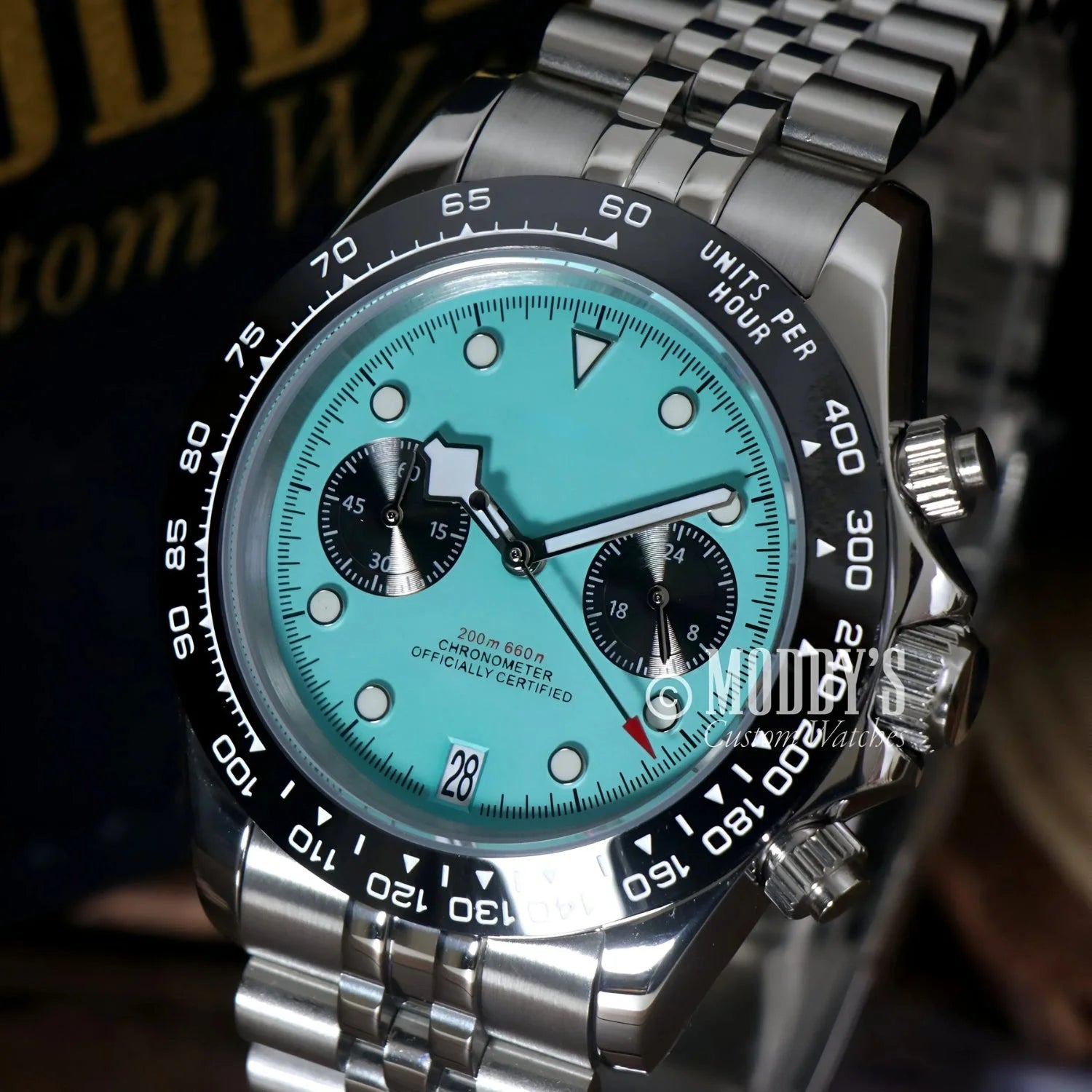 Silver wristwatch with turquoise face, featuring Seiko VK63 hybrid movement, Chrono Blue