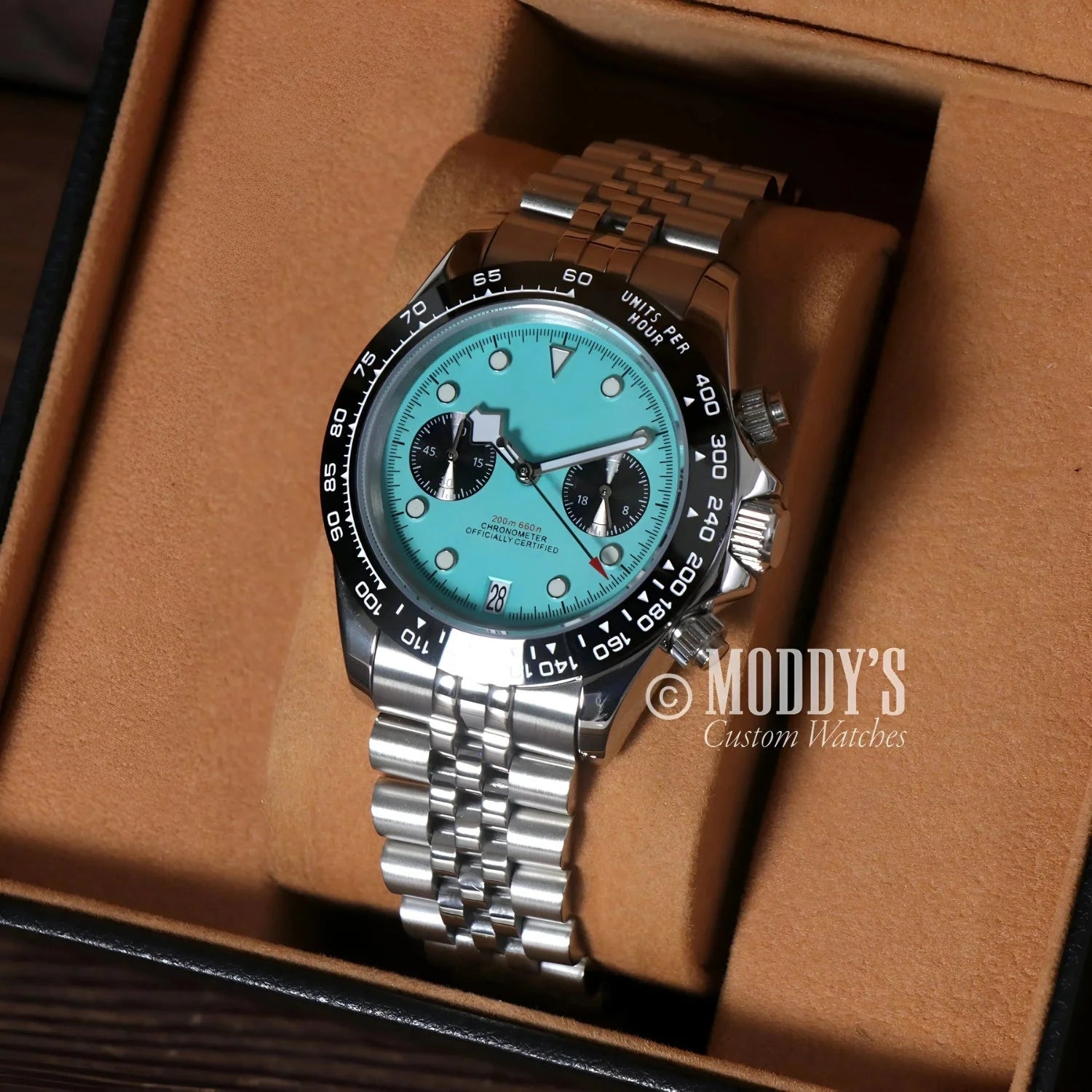 Silver wristwatch with turquoise face featuring Seiko VK63 hybrid movement, Chrono Blue