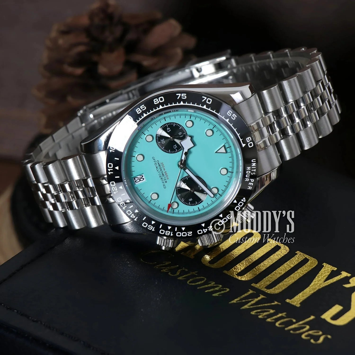 Silver wristwatch with turquoise face, featuring Seiko VK63 hybrid movement, Chrono Blue