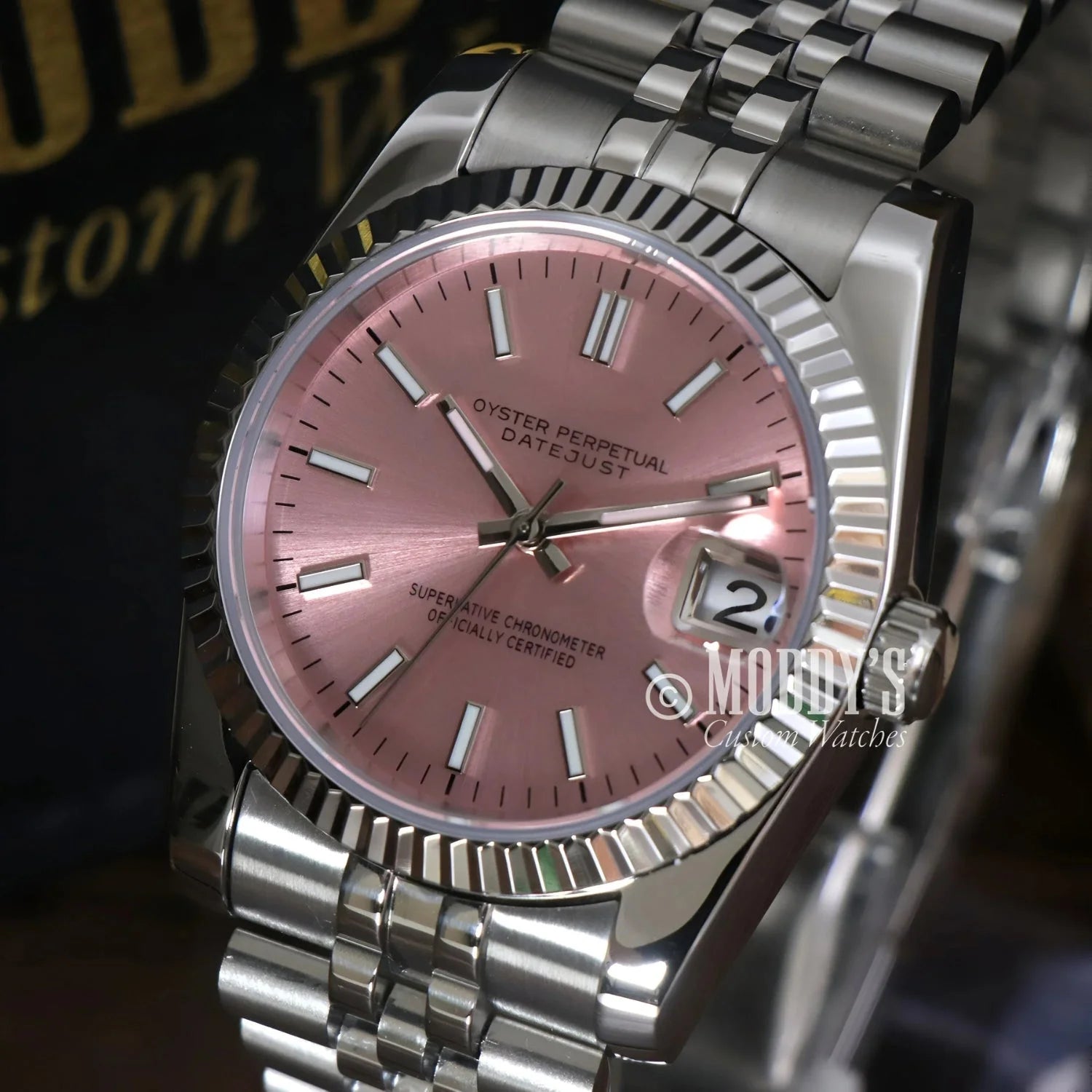 Silver Seikojust wristwatch with pink face, featuring Seiko NH35 automatic movement