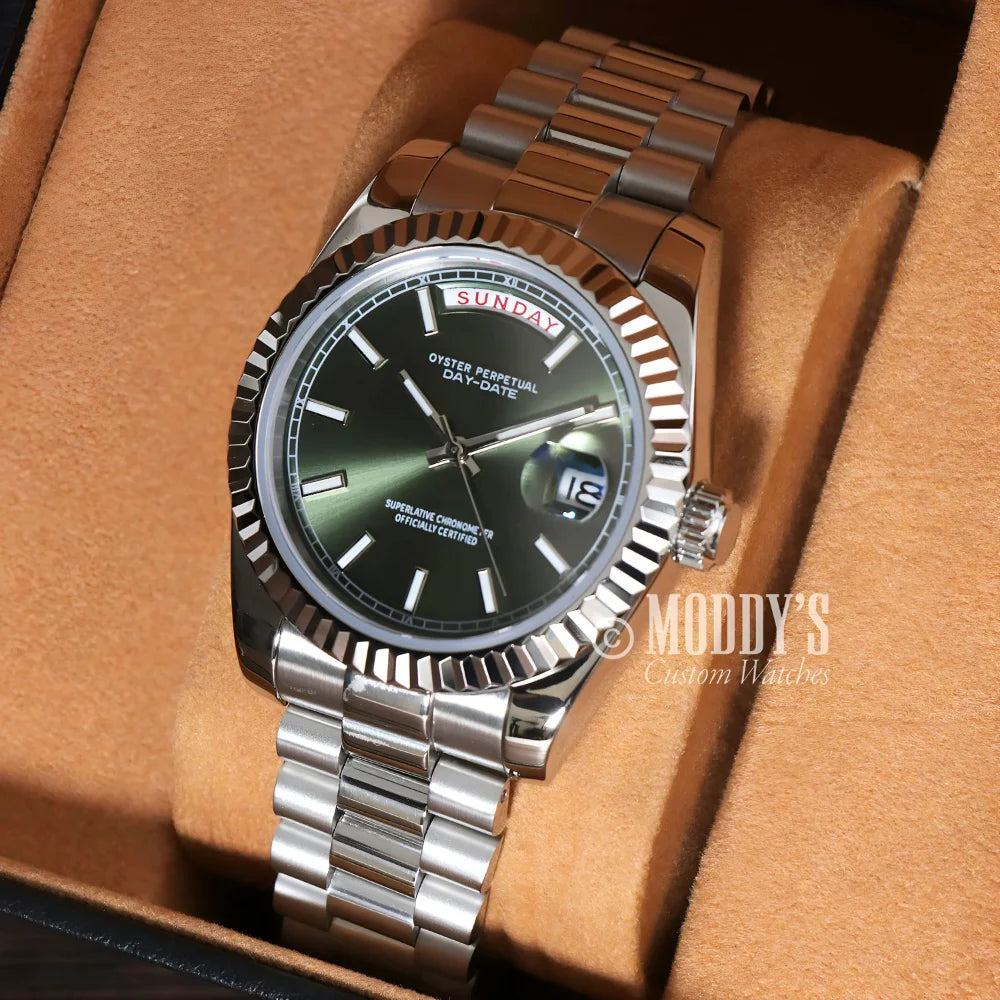 Silver Seiko Mod wristwatch with a green face, featuring 904L stainless steel case