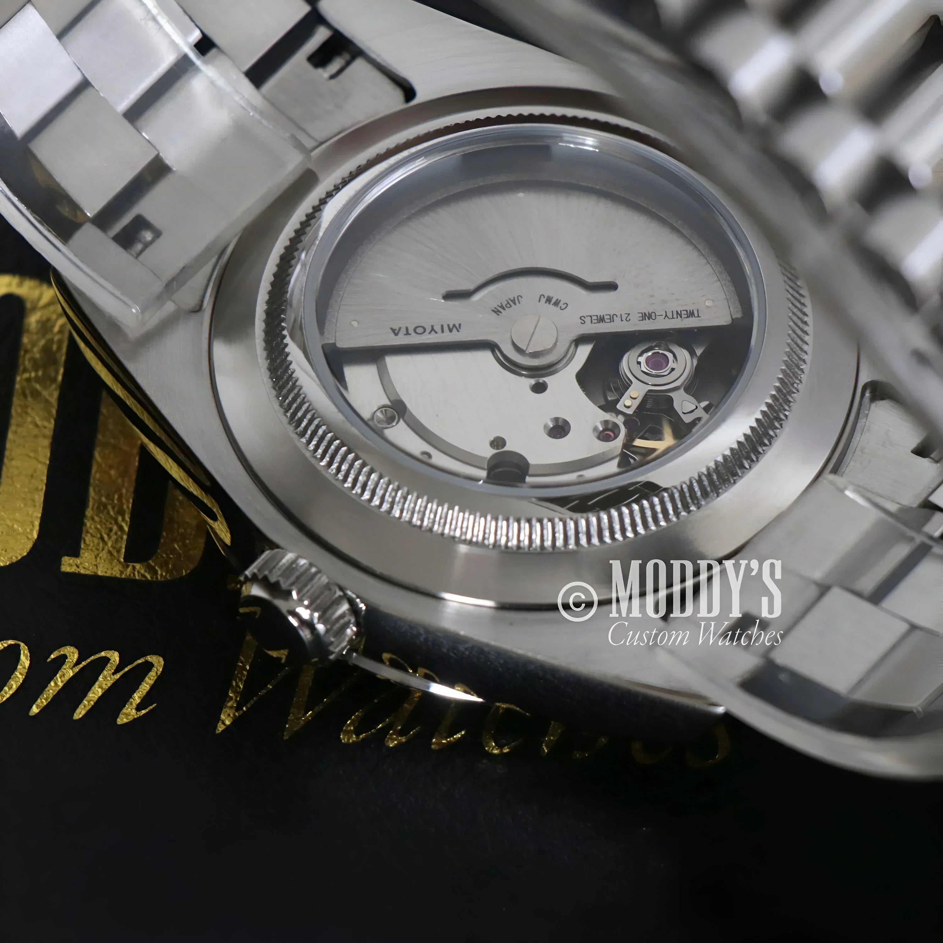 Silver Seikojust Daydate Mint Green wristwatch showcasing exposed movement and 904L stainless steel
