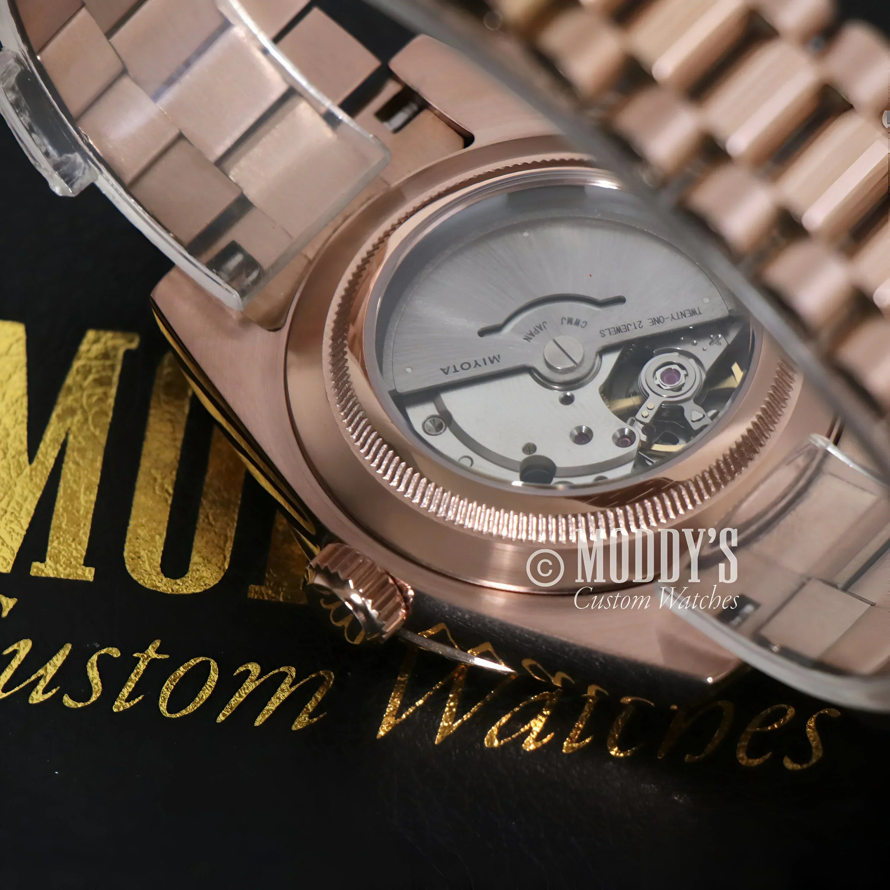 Rose gold wristwatch with visible movement from Seikojust Daydate Rose Gold collection