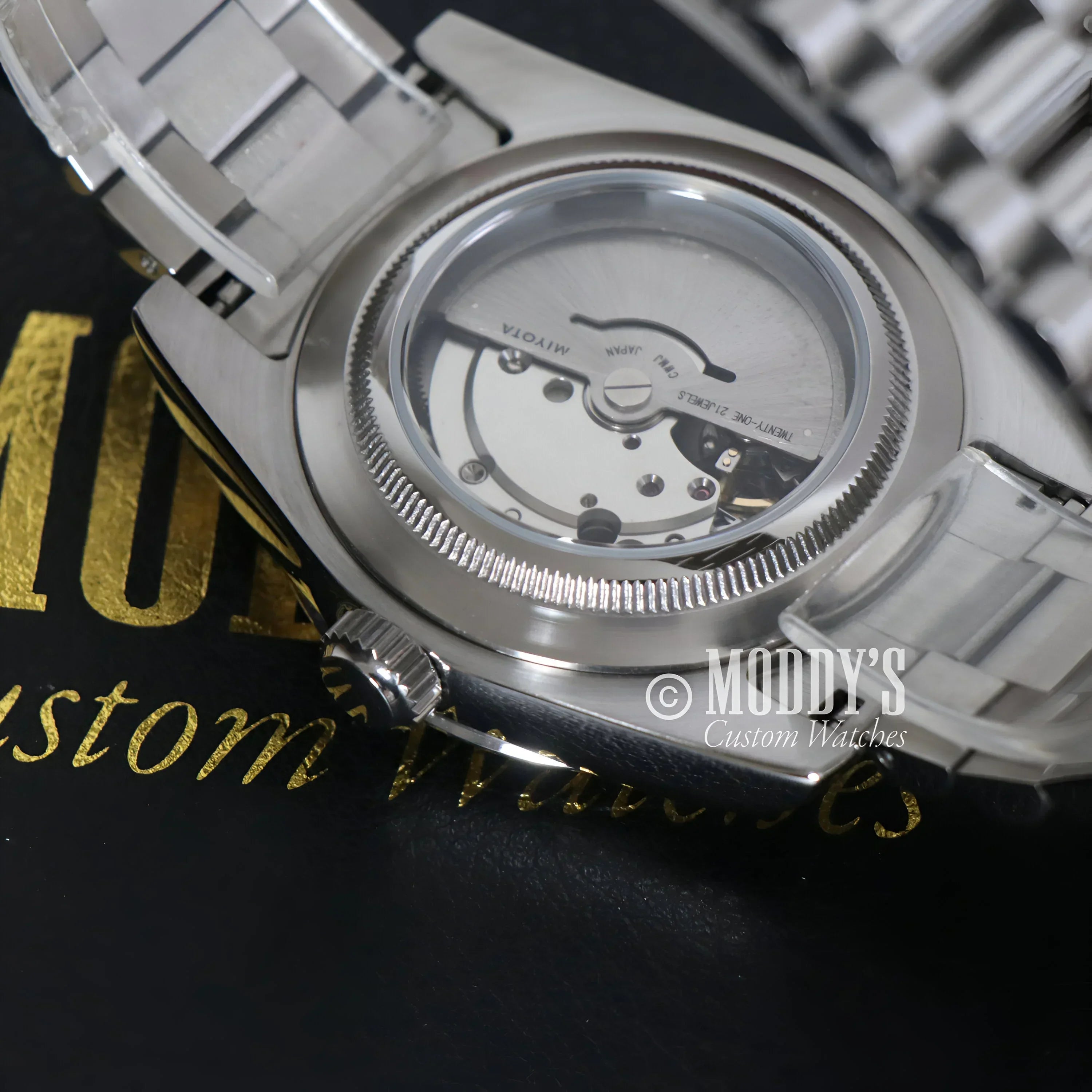 Silver wristwatch with exposed movement, Seikojust Daydate Royal Blue in 904L stainless steel