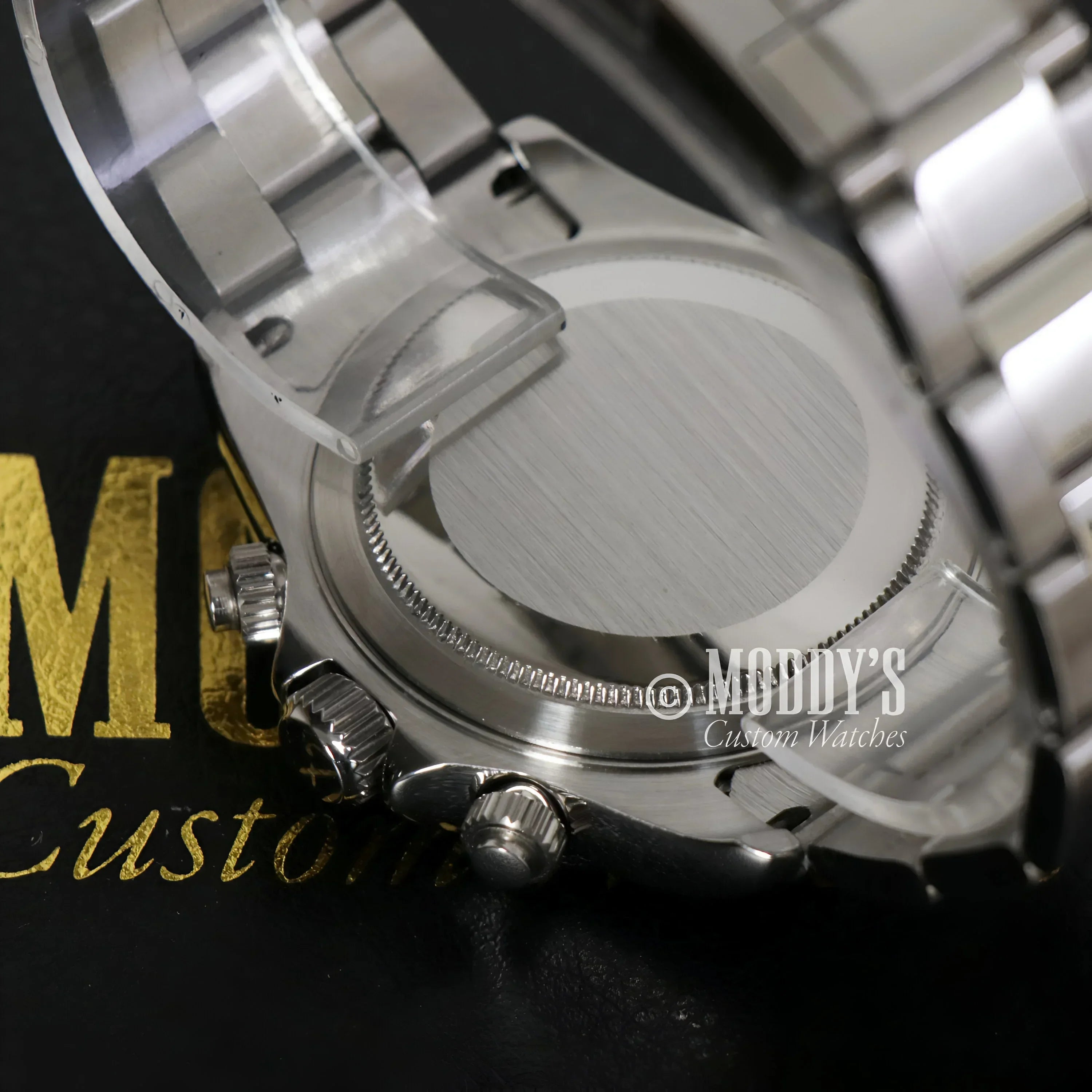 Silver wristwatch back of Seitona Black Panda featuring VK63 hybrid movement