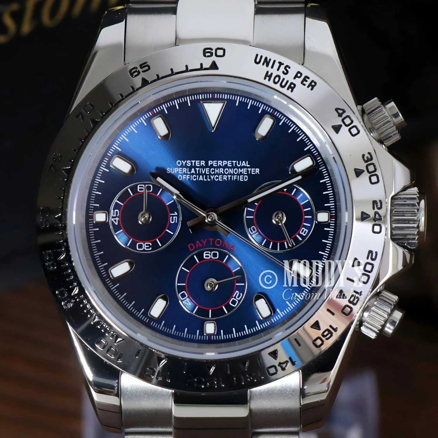Silver Rolex Daytona watch with blue face featuring Seiko VK63 hybrid movement