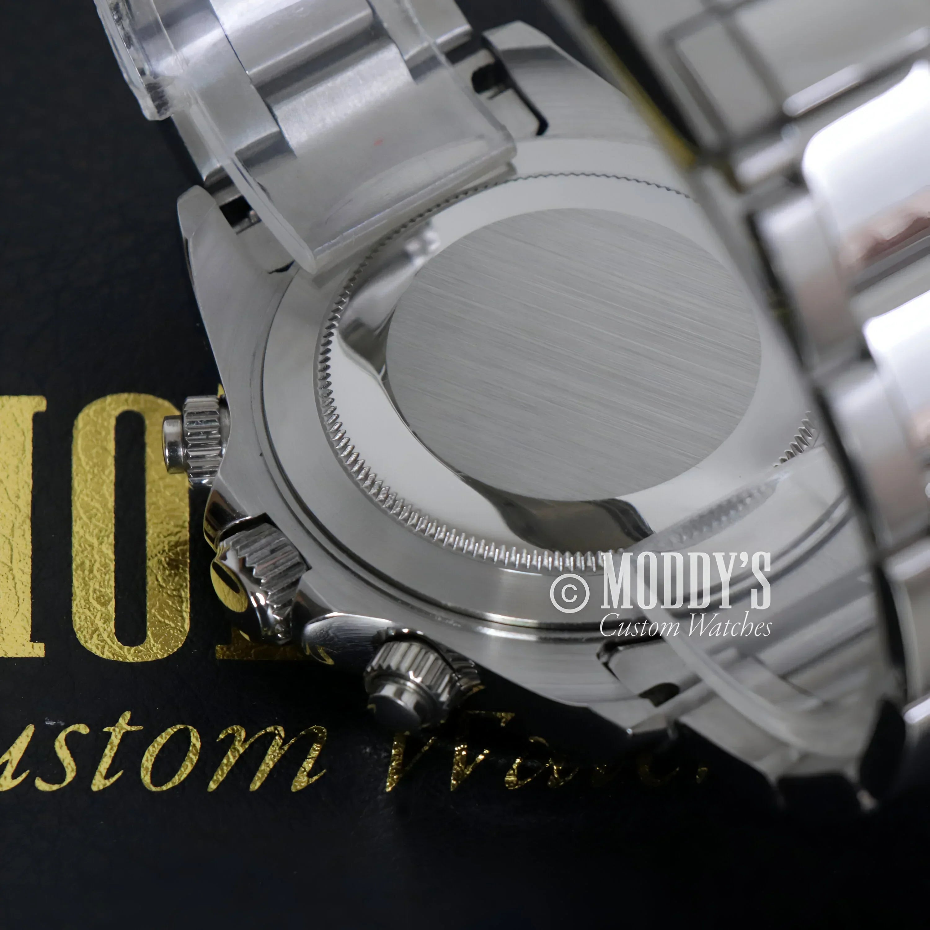 Silver wristwatch with chronograph pushers featuring Seiko VK63 hybrid movement