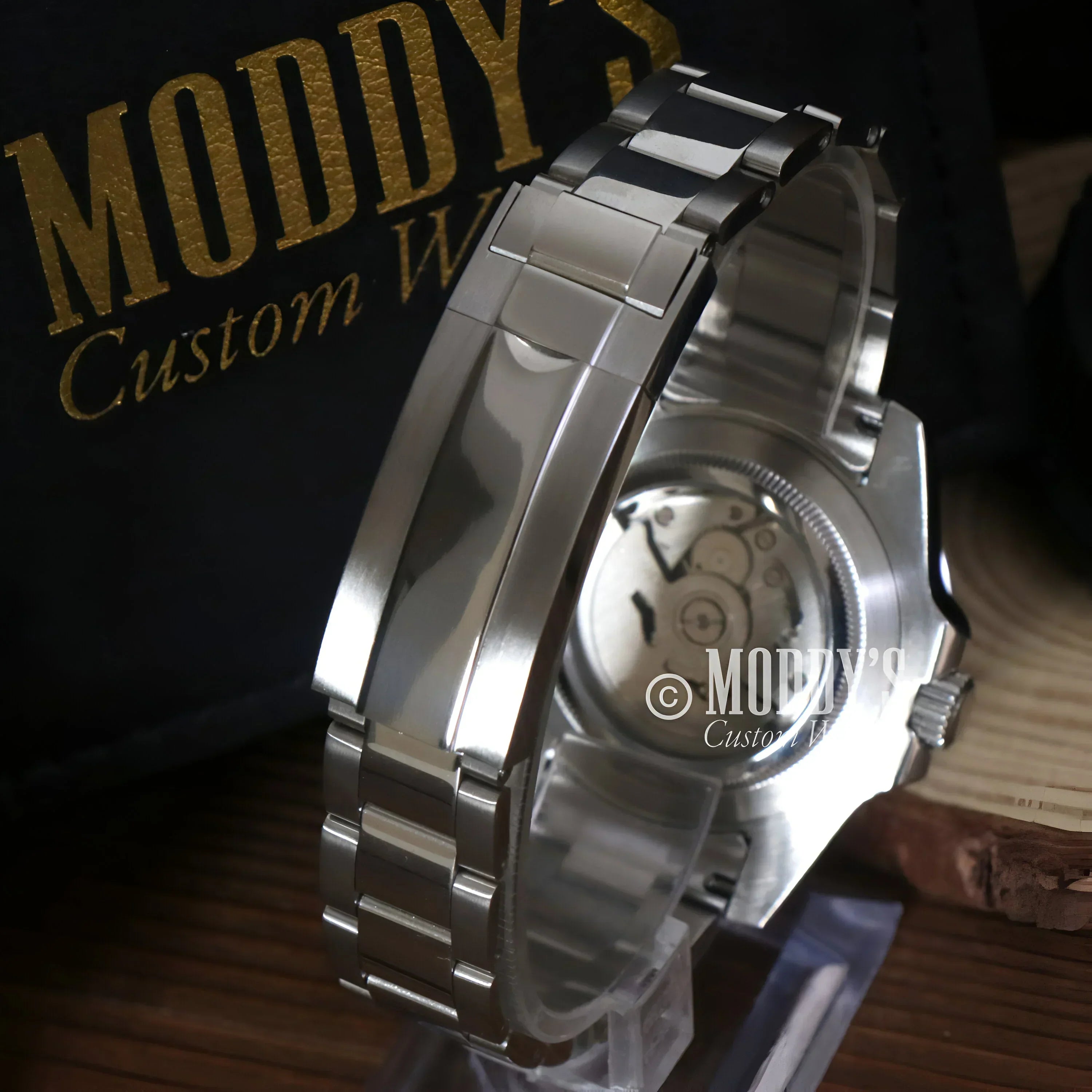 Silver wristwatch with exposed gears featuring NH34 automatic movement in GMTeiko Batman