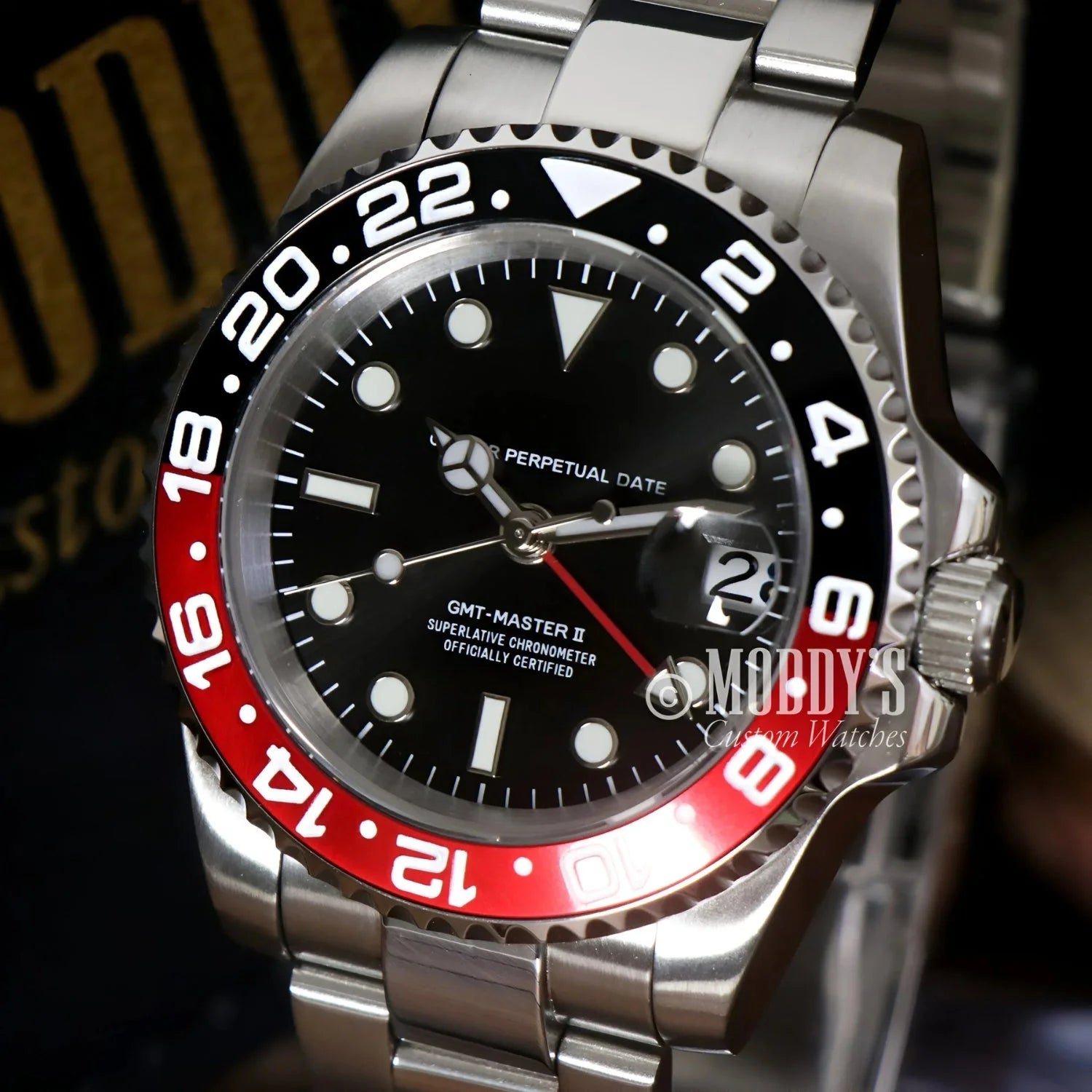 Silver GMTeiko Coke wristwatch with red and black bezel, featuring NH34 automatic movement