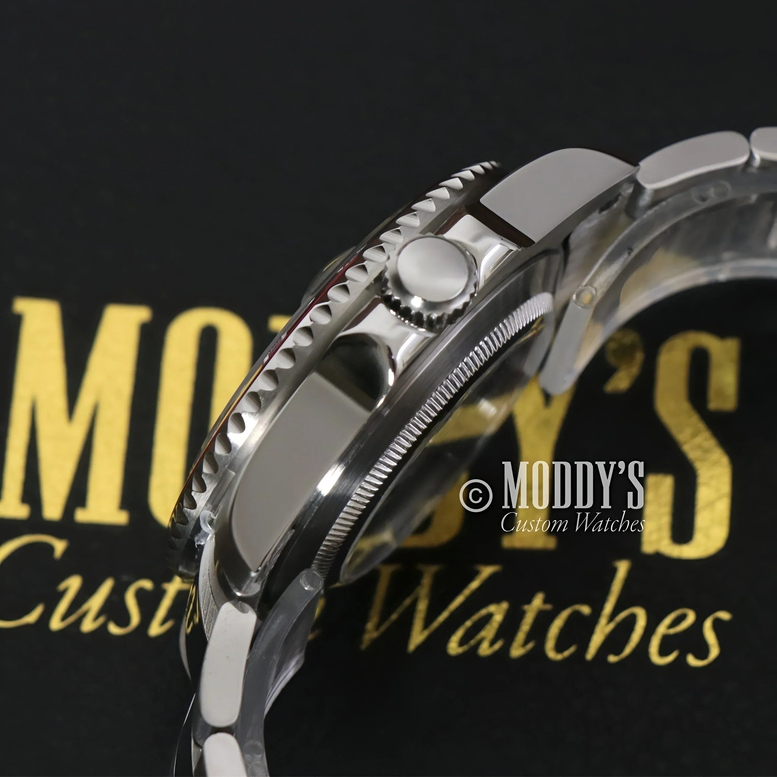 Silver wristwatch with rotating bezel, featuring Seiko Mod GMT and NH34 automatic movement