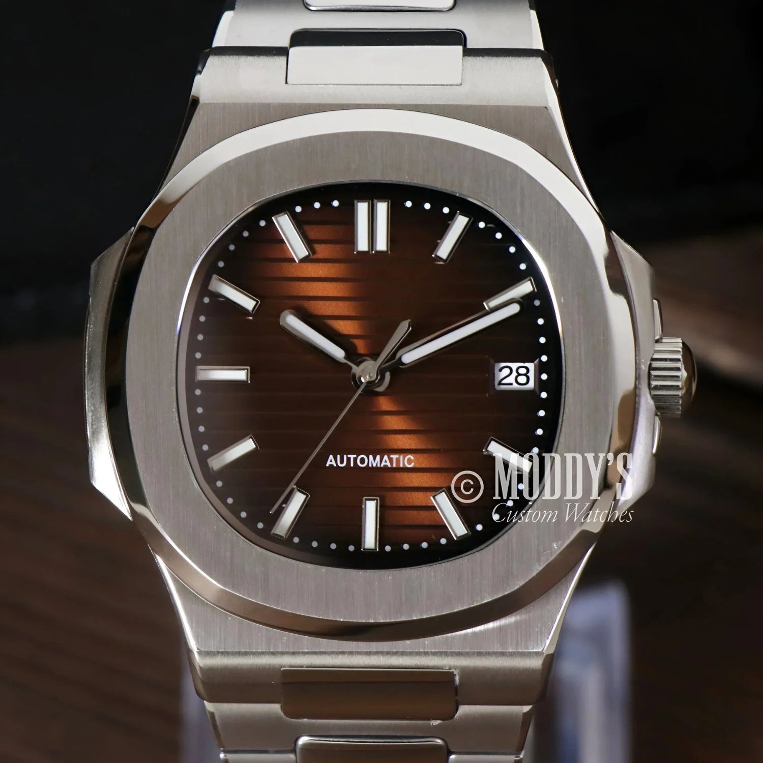 Silver wristwatch with brown face featuring Seiko NH35 automatic movement in Nautiko design