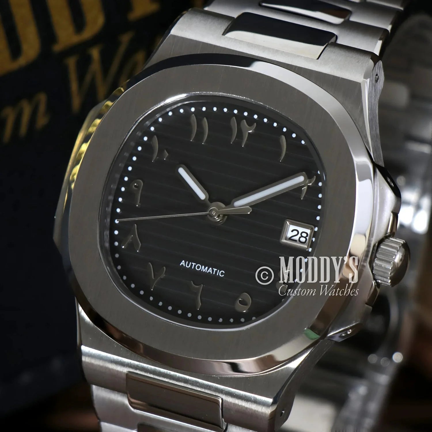Silver wristwatch with Arabic numerals featuring NH35 automatic movement and 904L stainless steel