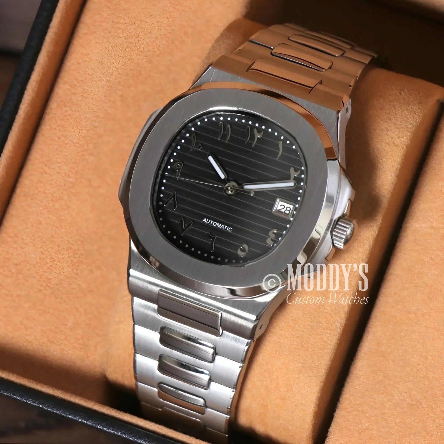 Silver wristwatch with black face featuring NH35 automatic movement in 904L stainless steel