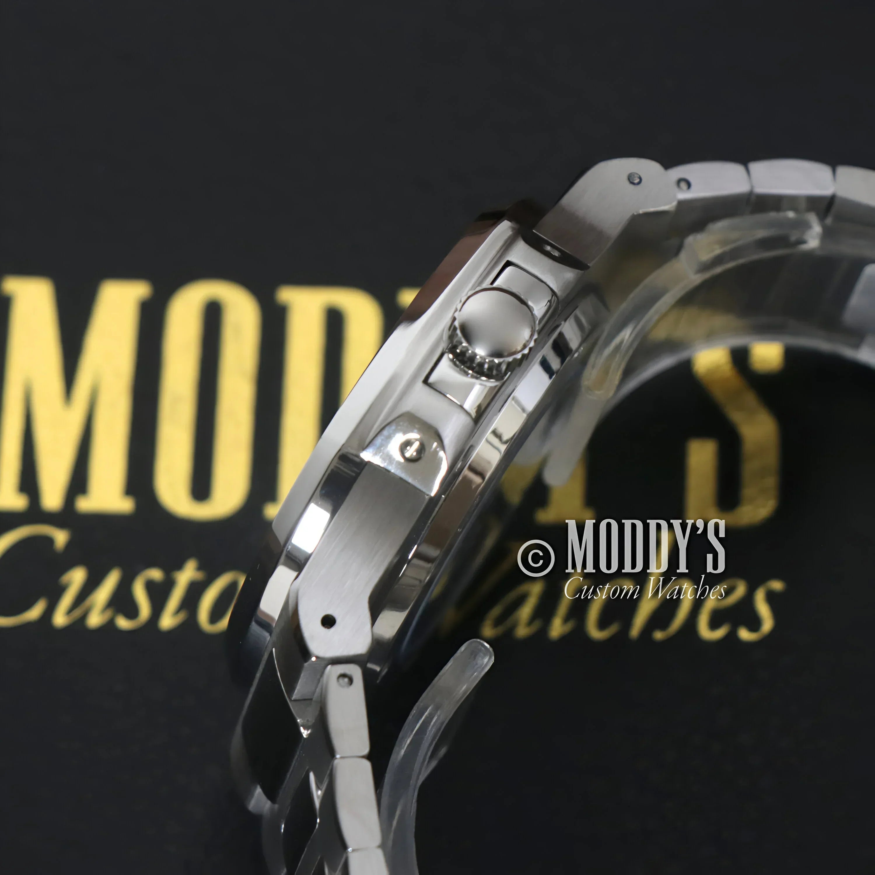Silver wristwatch with metal band featuring NH35 automatic movement and 904L stainless steel