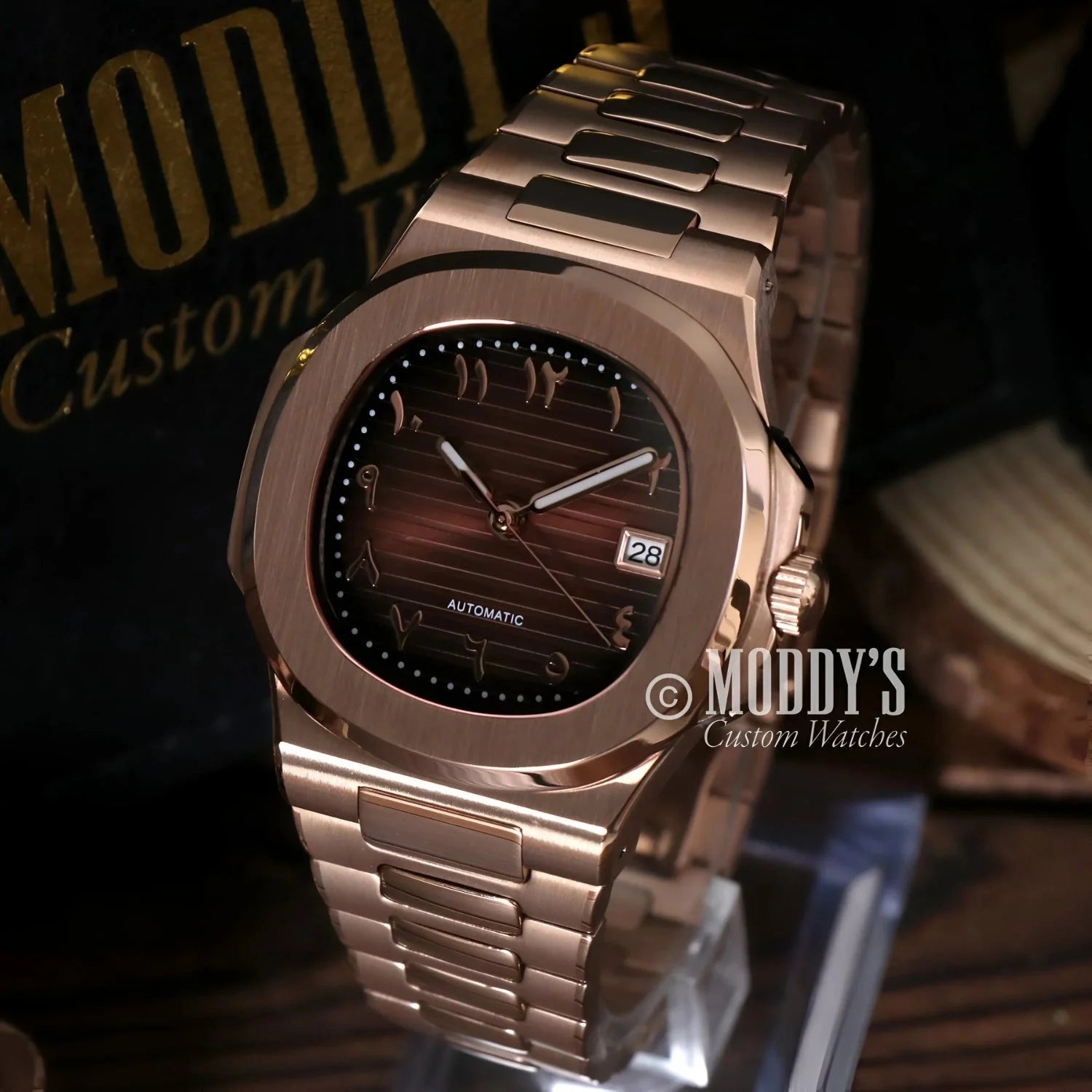 Rose gold wristwatch with Arabic numerals featuring NH35 automatic movement and 904L stainless steel