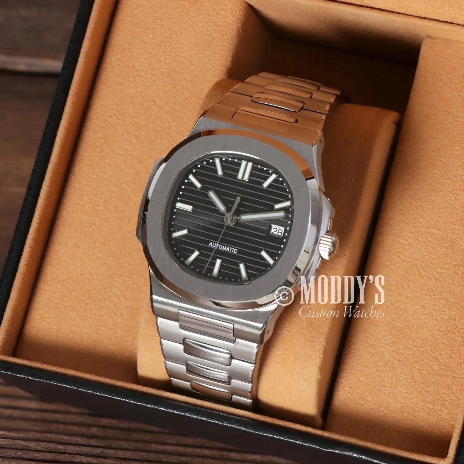 Silver wristwatch with black face featuring NH35 automatic movement in 904L stainless steel