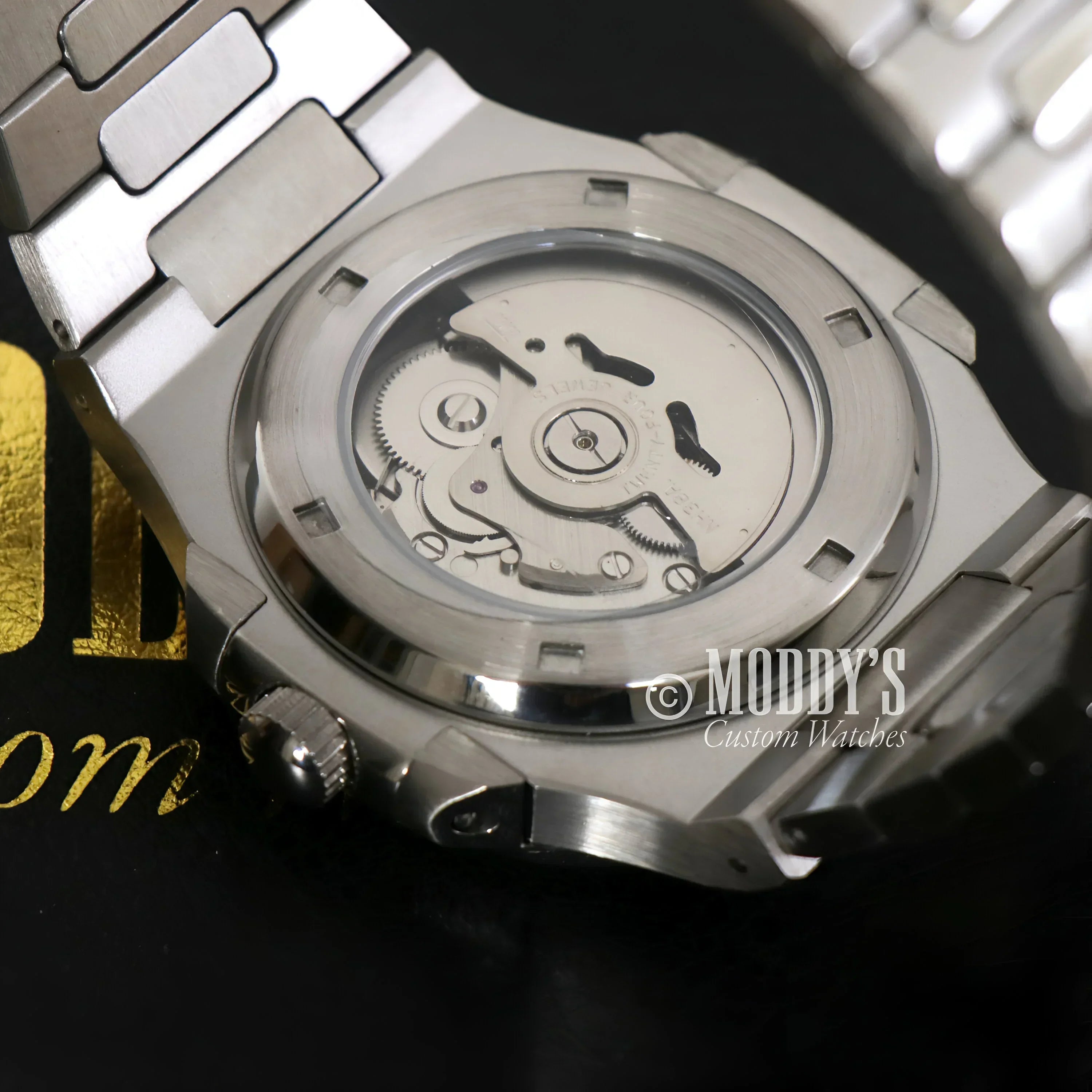 Silver Nautiko Black Open Movement wristwatch showcasing NH38 automatic movement