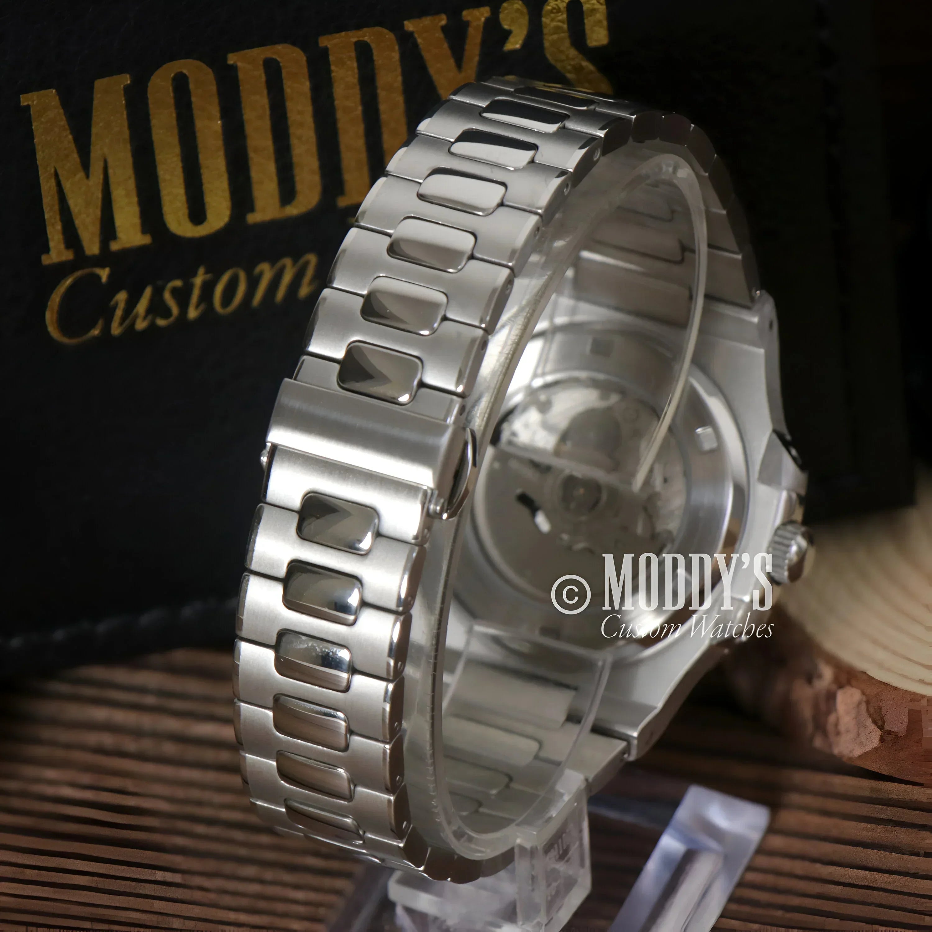 Silver wristwatch with metal band, featuring NH38 automatic movement and 904L stainless steel