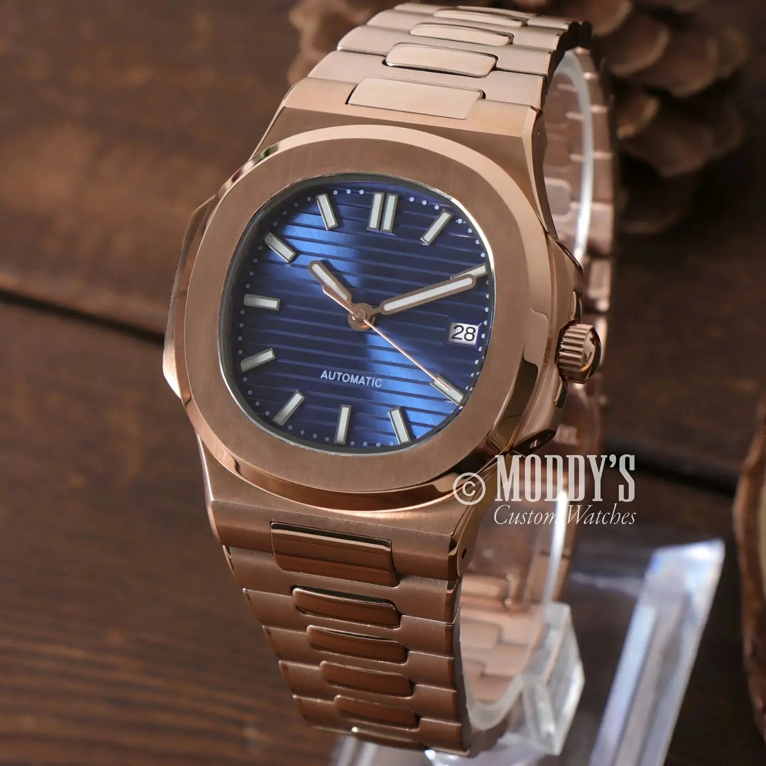 Rose Gold wristwatch with blue face, featuring NH35 automatic movement and 904L stainless steel