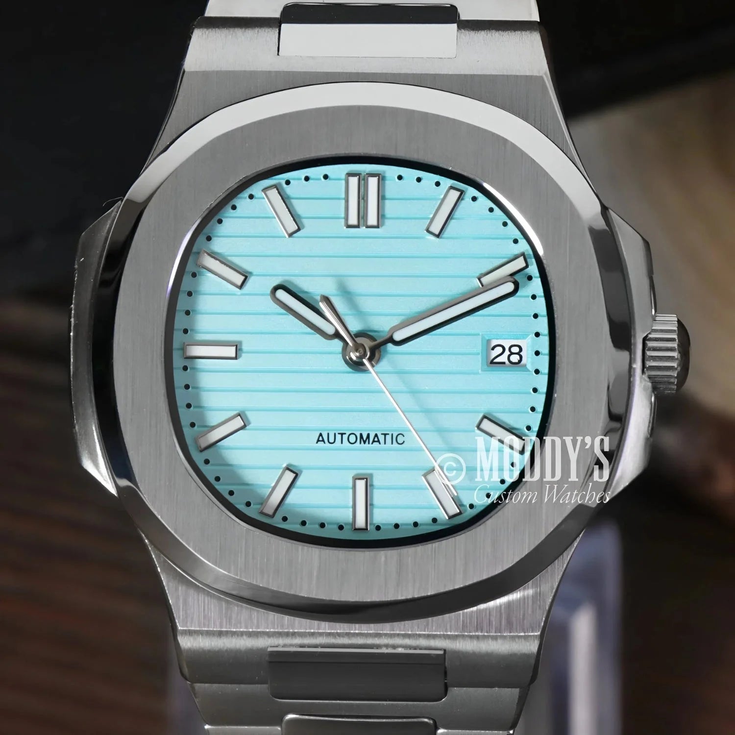 Silver wristwatch with a turquoise face, featuring NH35 automatic movement and Tiffany Blue accents